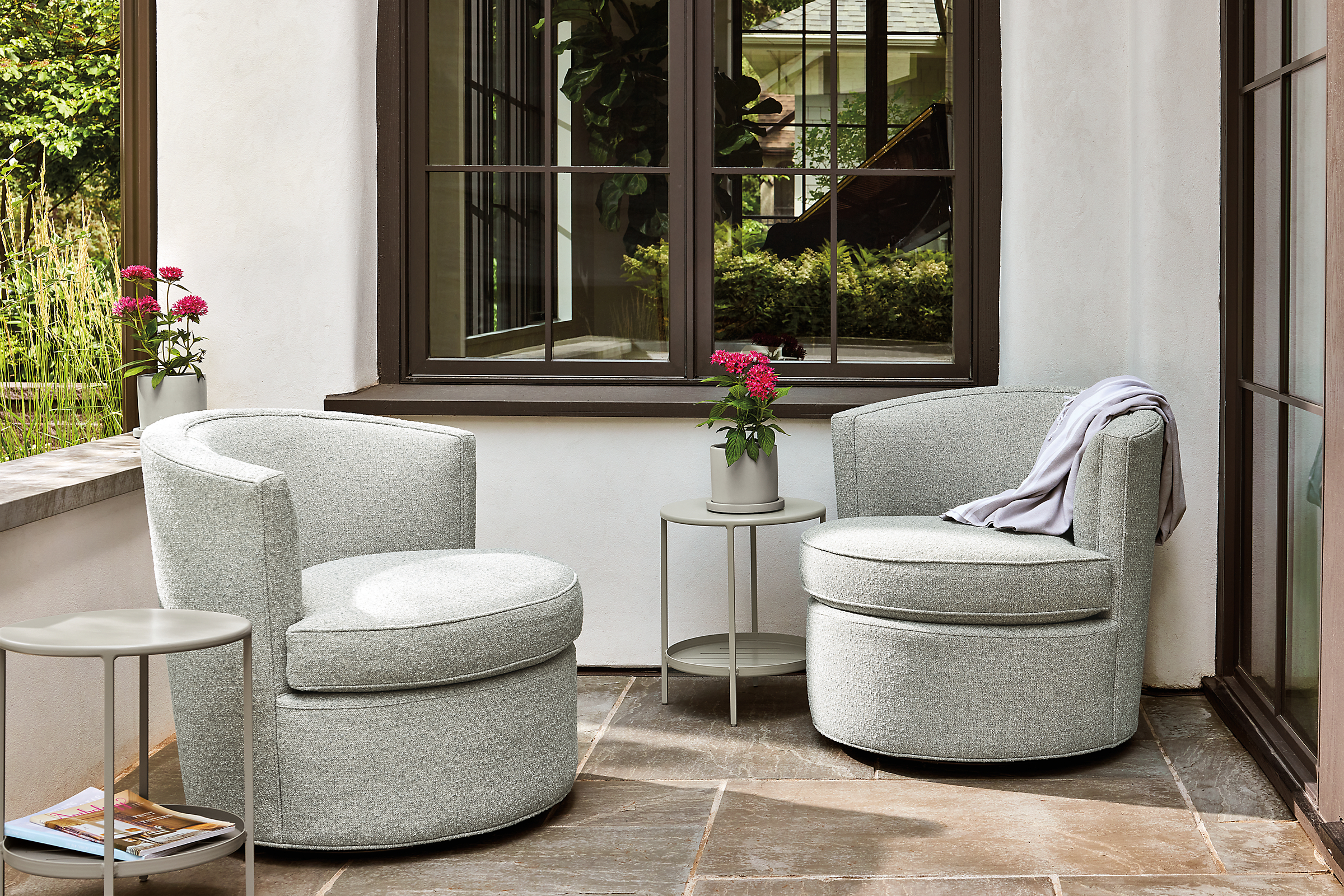 outdoor space with 2 ambrose swivel chairs in kloss cadet fabric.