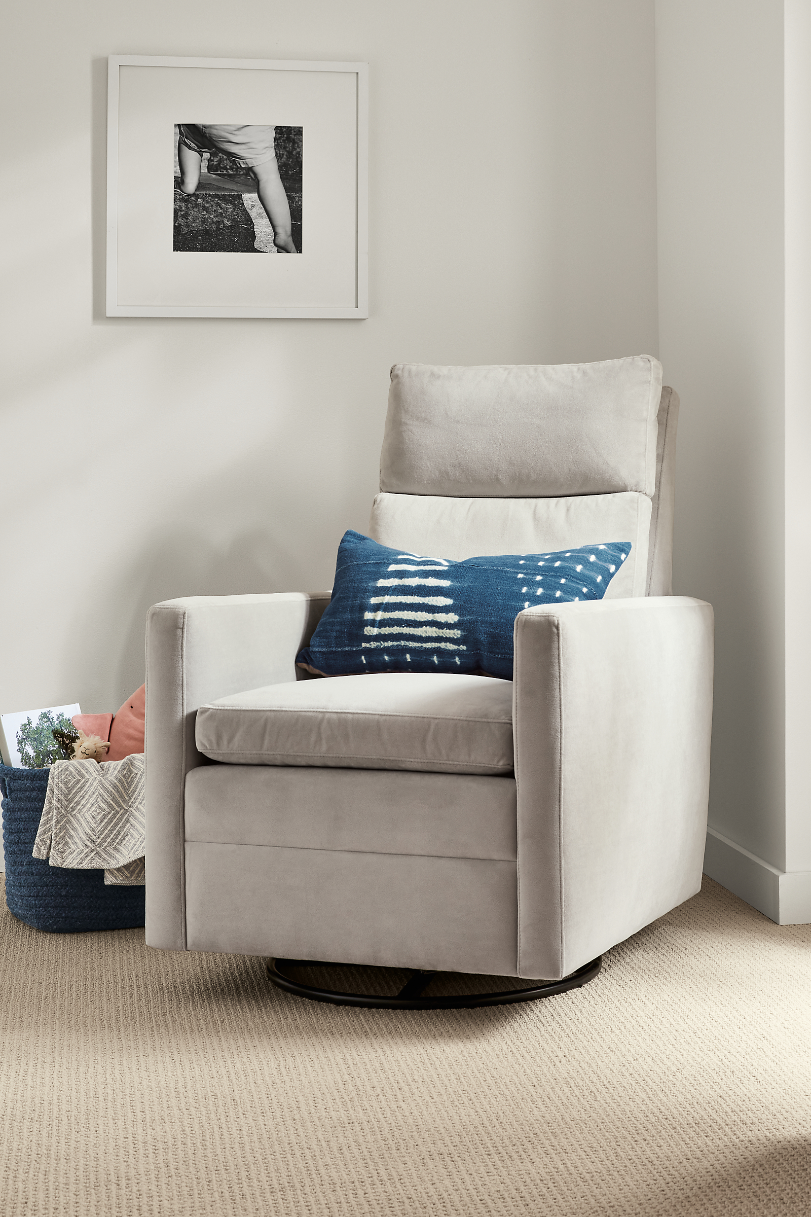 Ambry Swivel Glider in View Grey with Gouro Throw Pillow in Indigo.