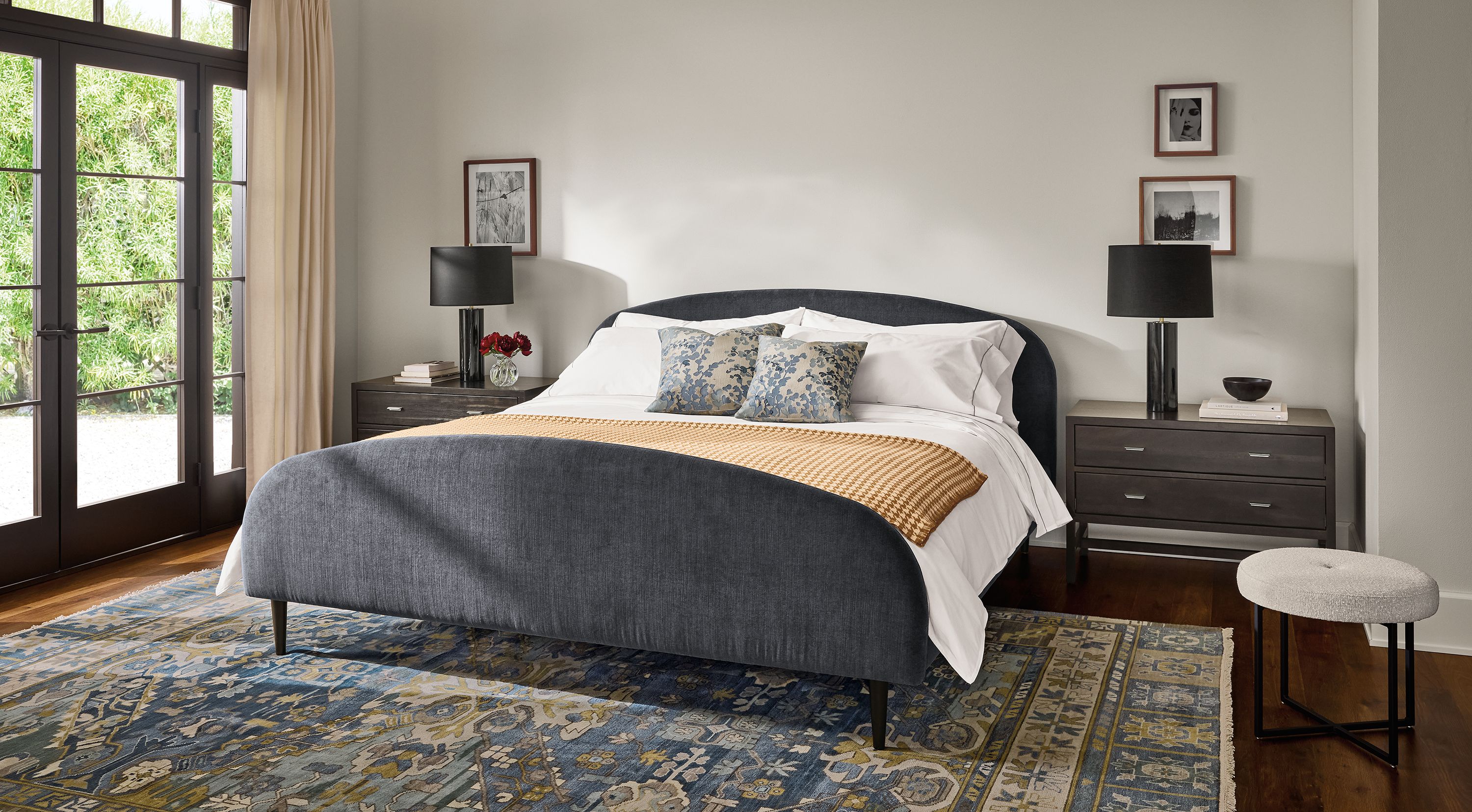 Bedroom with Amelia king bed in windsor navy, 2 Berkeley 2-drawer nightstands in charcoal and Kayseri rug in marine.