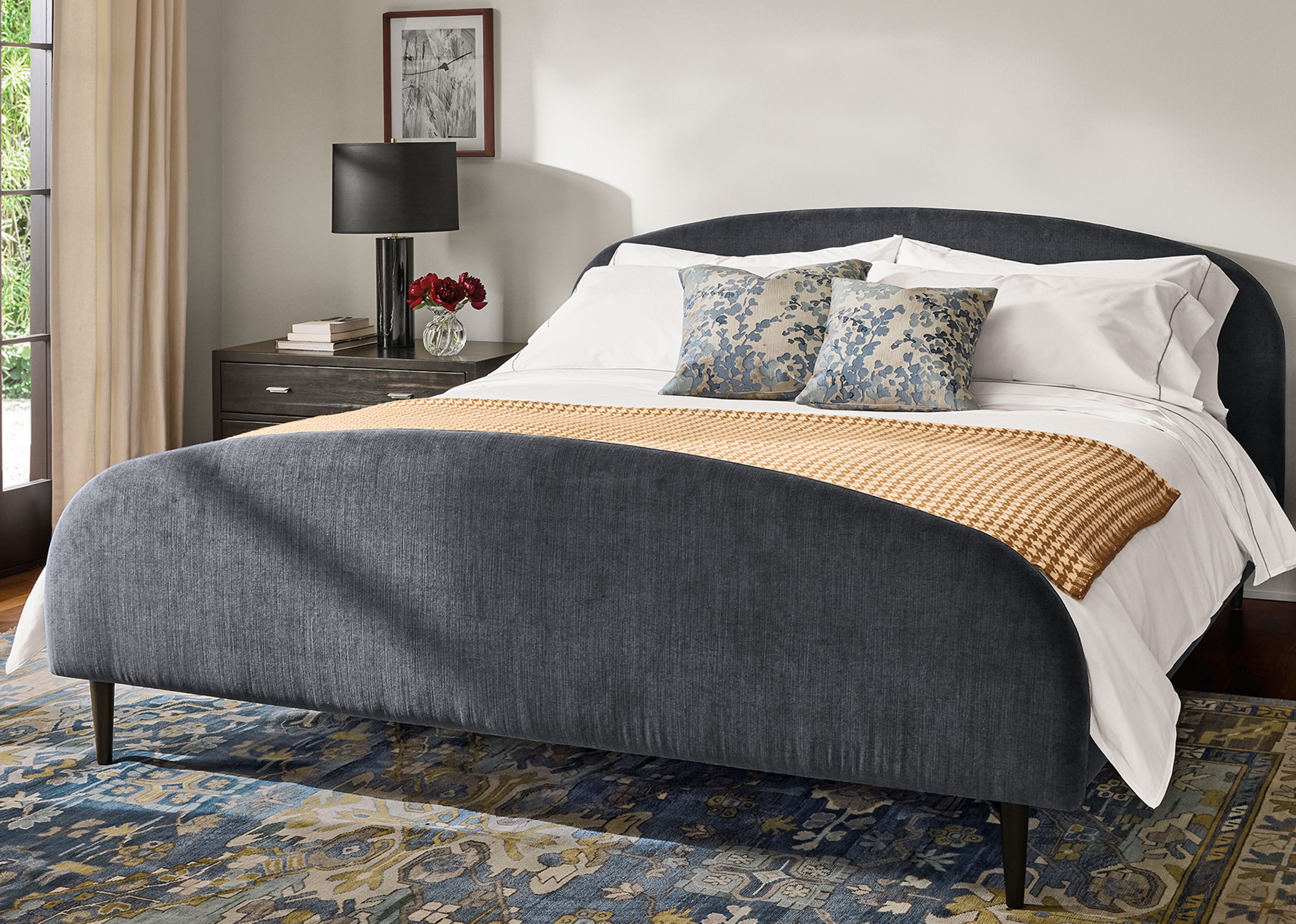 Bedroom with Amelia king bed in windsor navy, 2 Berkeley 2-drawer nightstands in charcoal and Kayseri rug in marine.