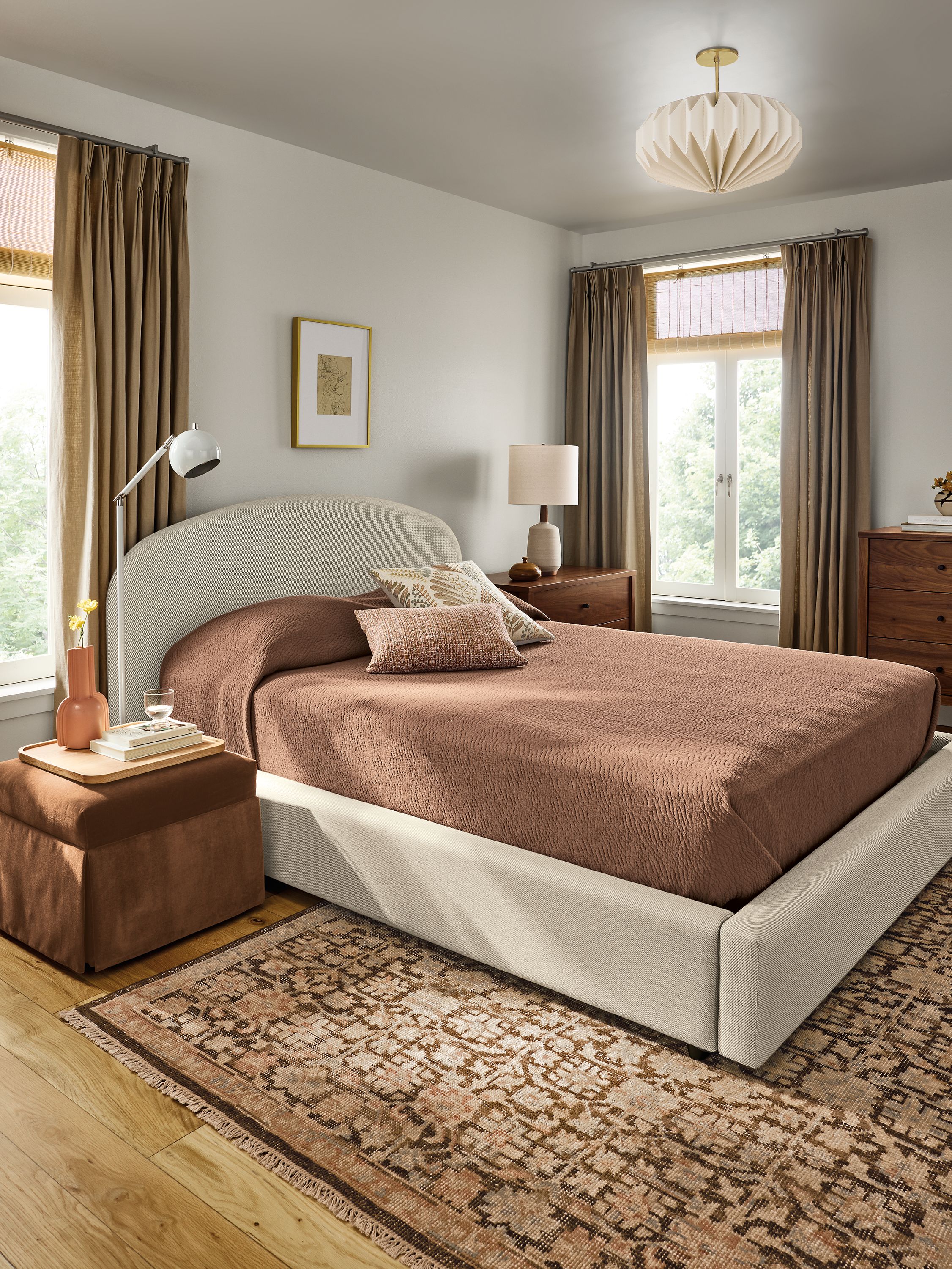 Bedroom with Amelia Queen storage bed in Derry flax, Emerson nightstand and dresser in walnut and Rosalie rug in petal.
