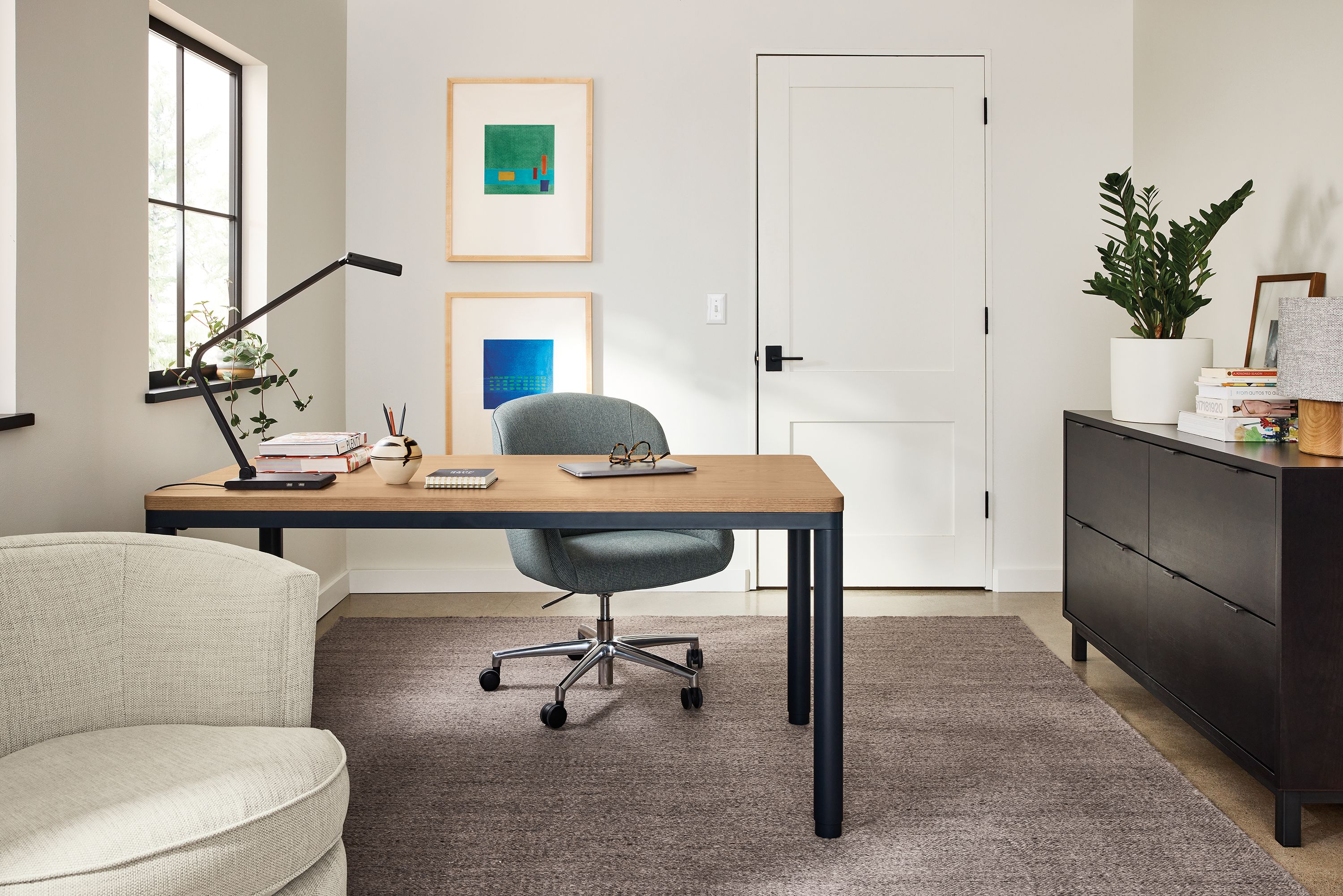 Home office with Ames adjustable standing desk in graphite and rye on red oak and Avilia rug in foxhound.