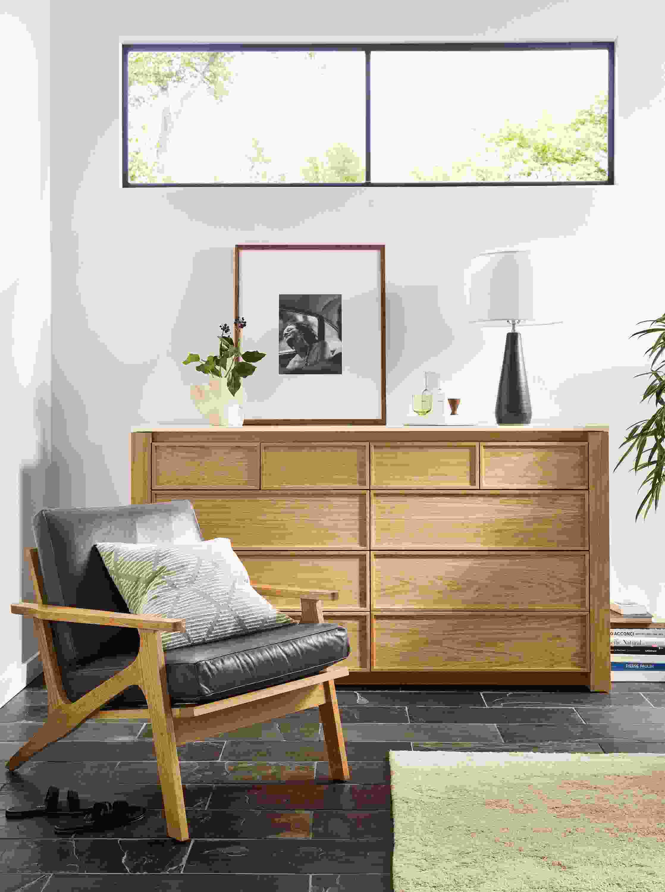 Living room with Amherst 72-wide 10-drawer dresser in white oak next to sanna chair in Vento Smoke leather.