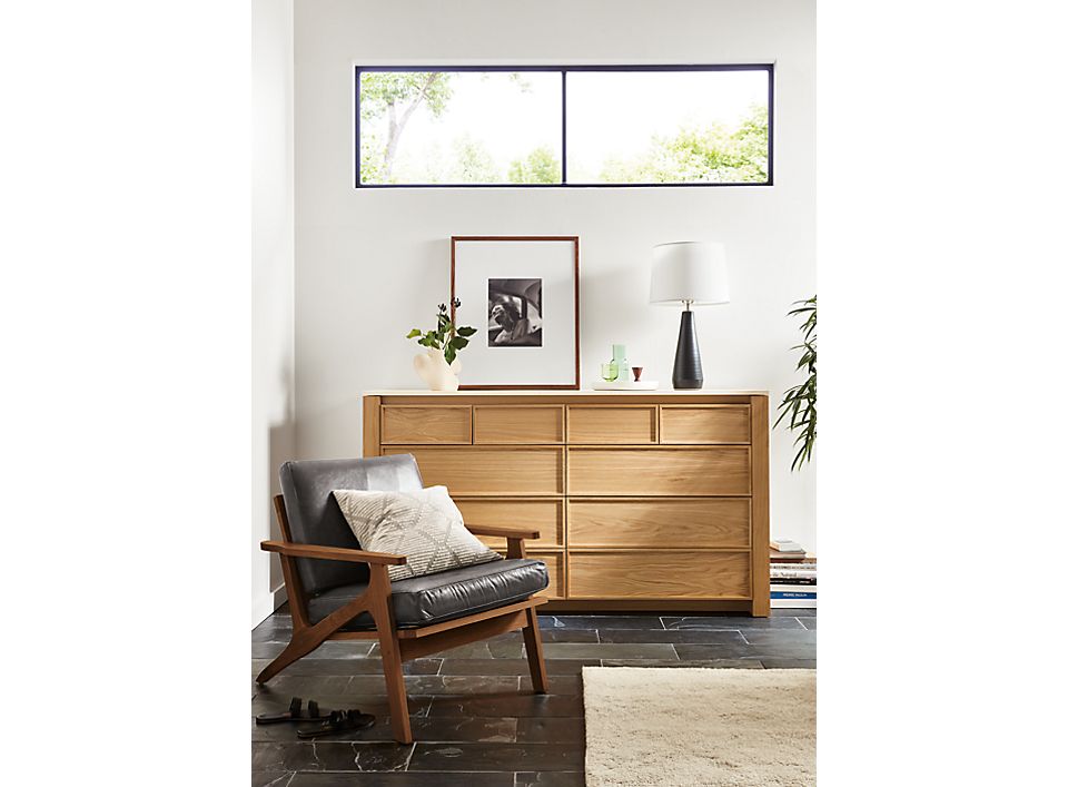 amherst 72-wide 10-drawer dresser in white oak next to sanna chair in walnut.