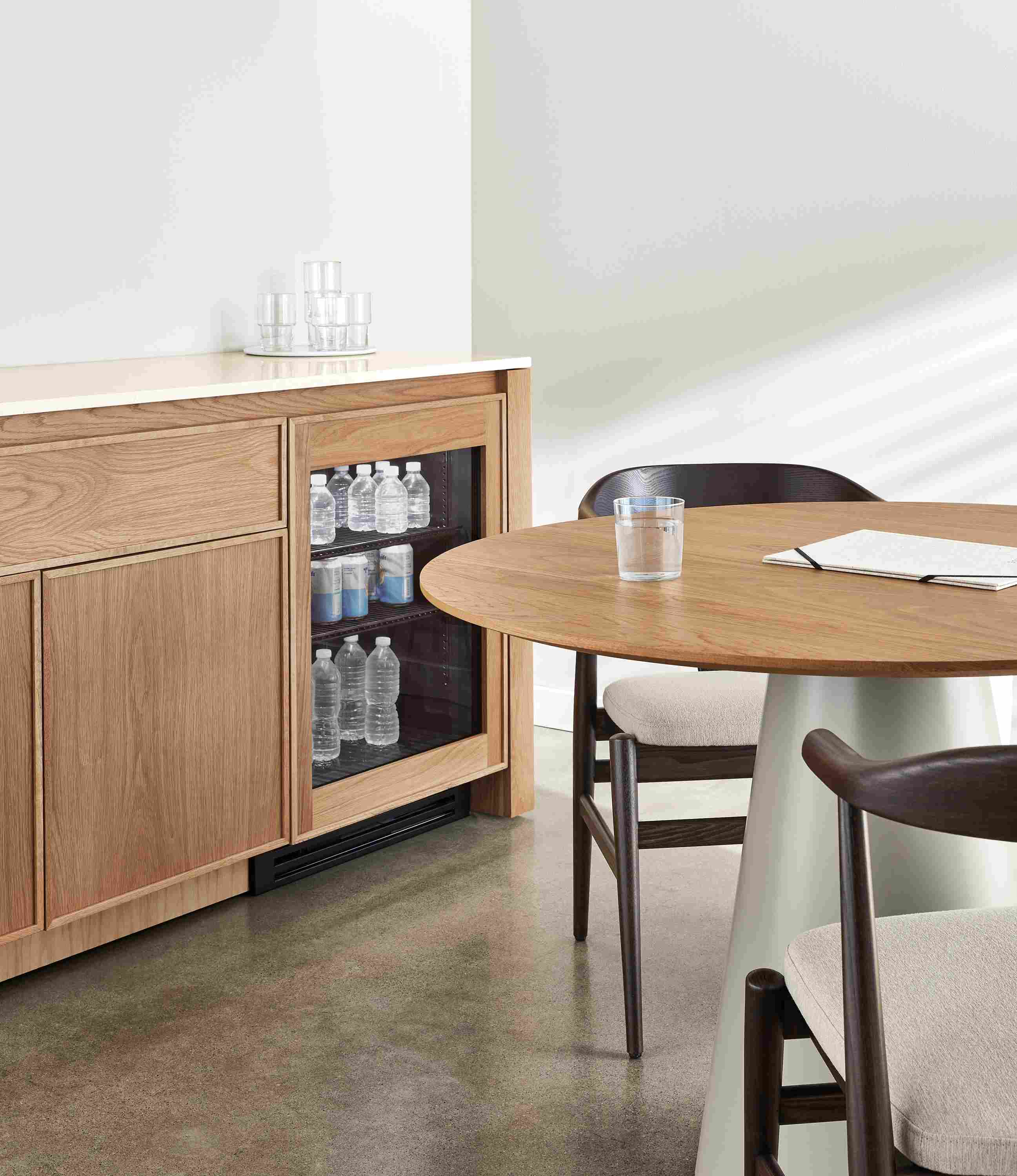 Dining area with Amherst 72-wide storage cabinet in rye on red oak with refrigerator door two-door shelf.