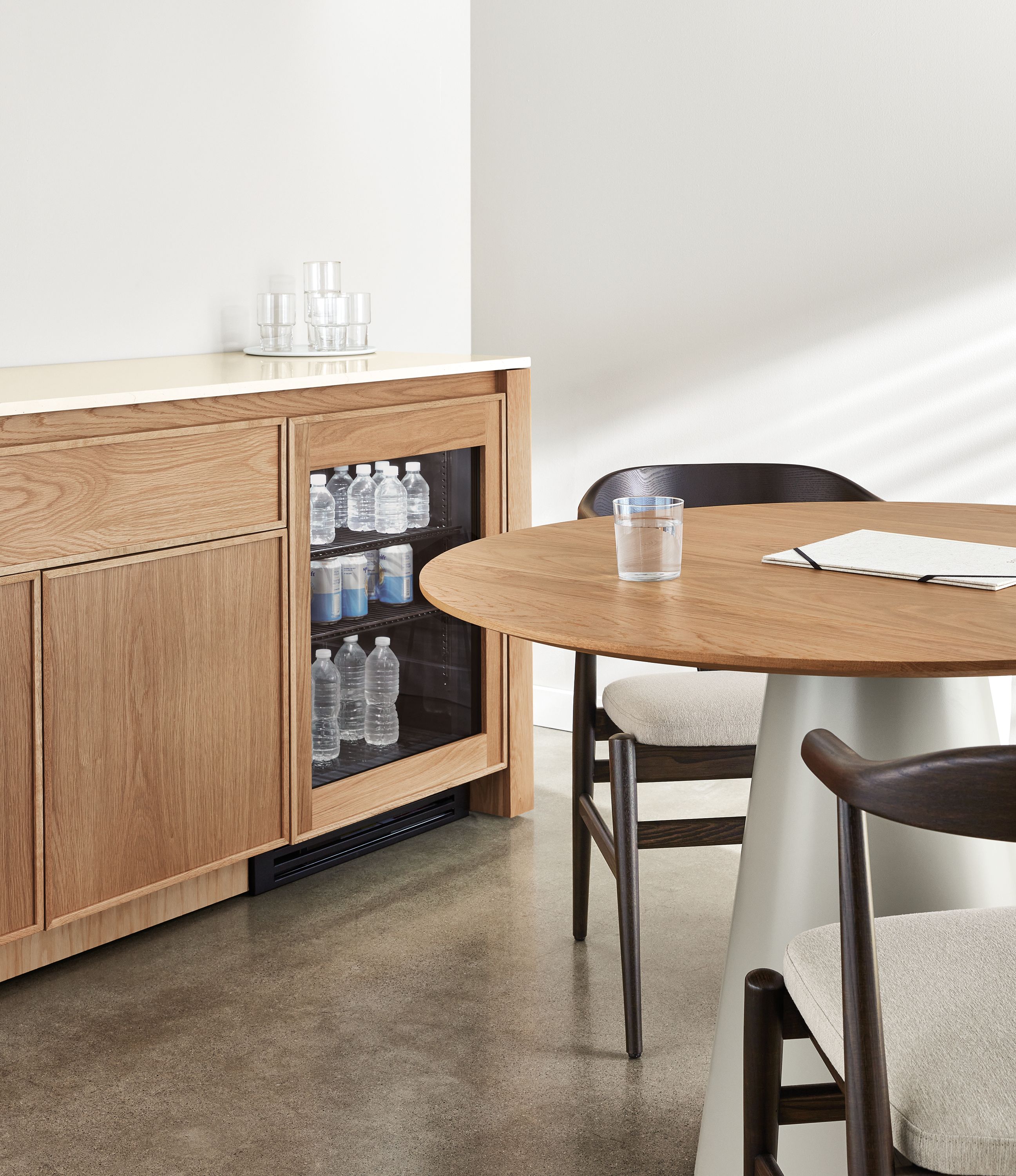 Dining area with Amherst 72-wide storage cabinet in rye on red oak with refrigerator door two-door shelf.