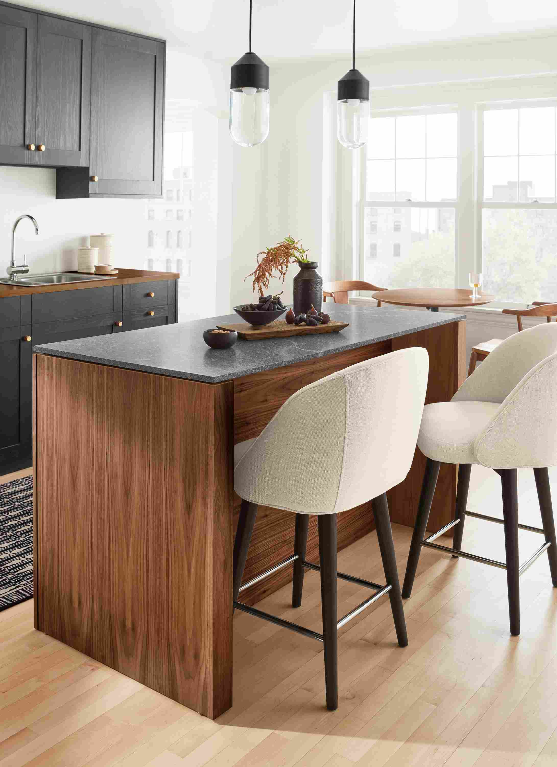 Amherst 60-wide Kitchen Island in walnut with Cora Swivel Counter Stool in Sumner Ivory.