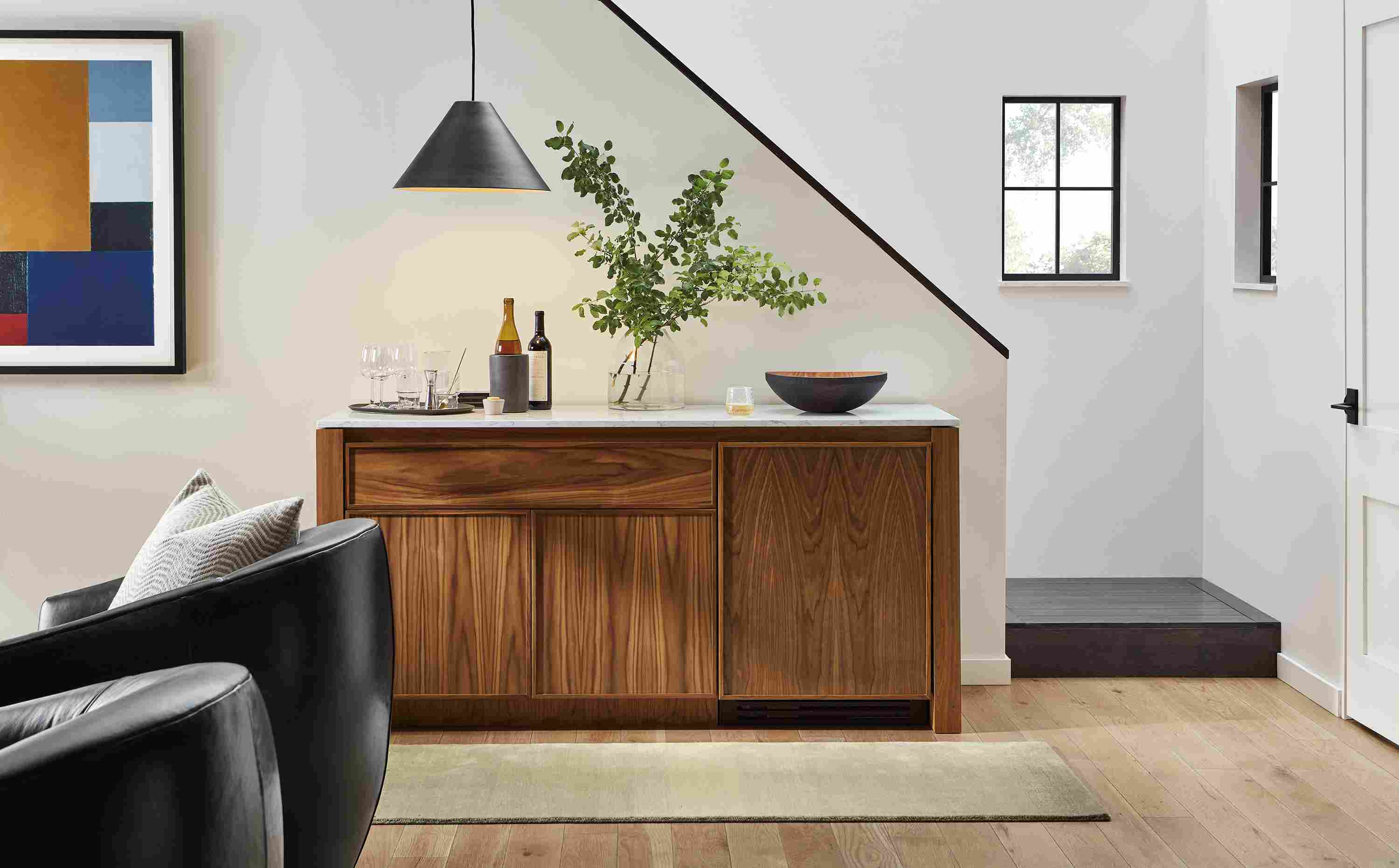 Great room with Amherst 72-wide storage cabinet with wood refrigerator door in walnut and Luco rug in silver.