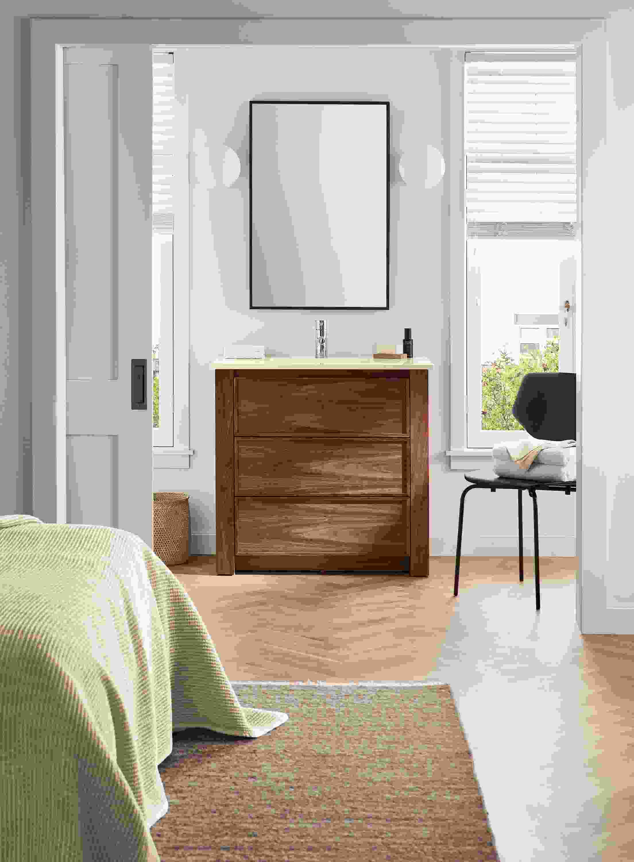 bedroom with 36-wide amherst vanity, hudson mirror, pike side chair, orbit sconces.