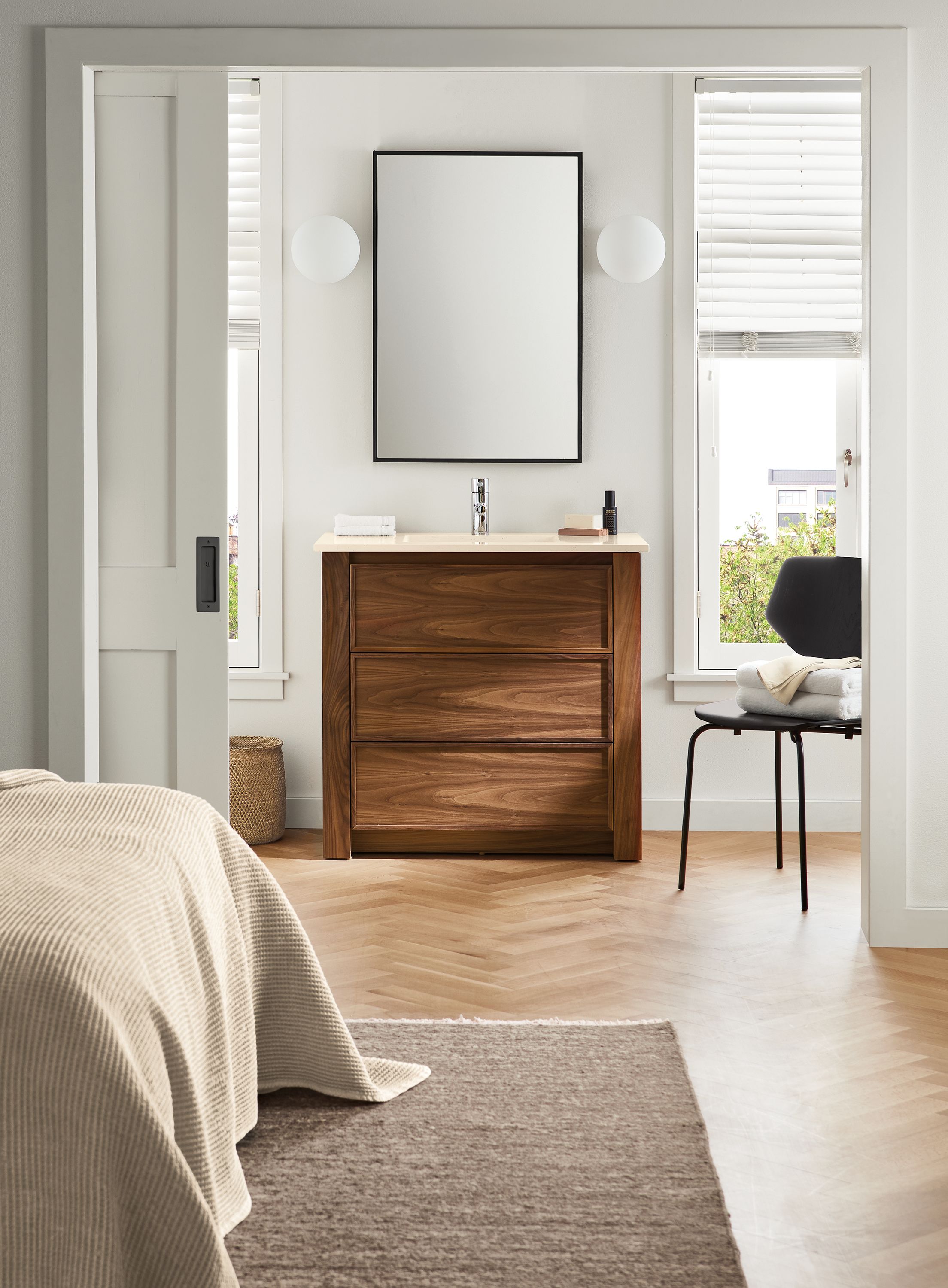 bedroom with 36-wide amherst vanity, hudson mirror, pike side chair, orbit sconces.