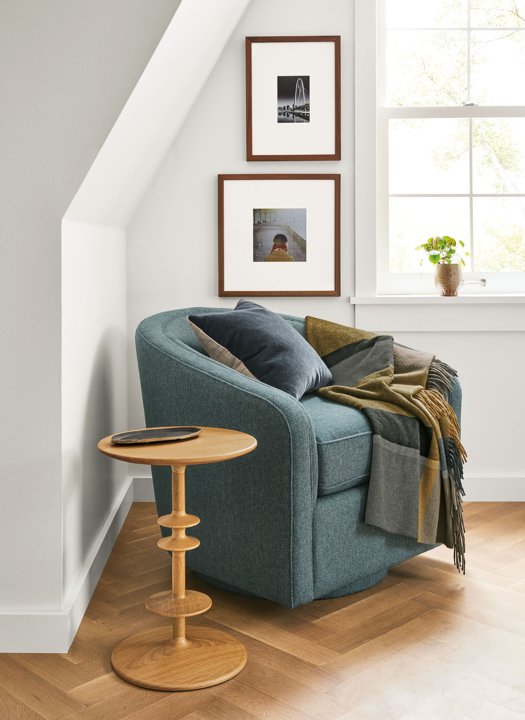 Detail of Amos swivel chair in Tepic Haze fabric beside white oak Parks table.