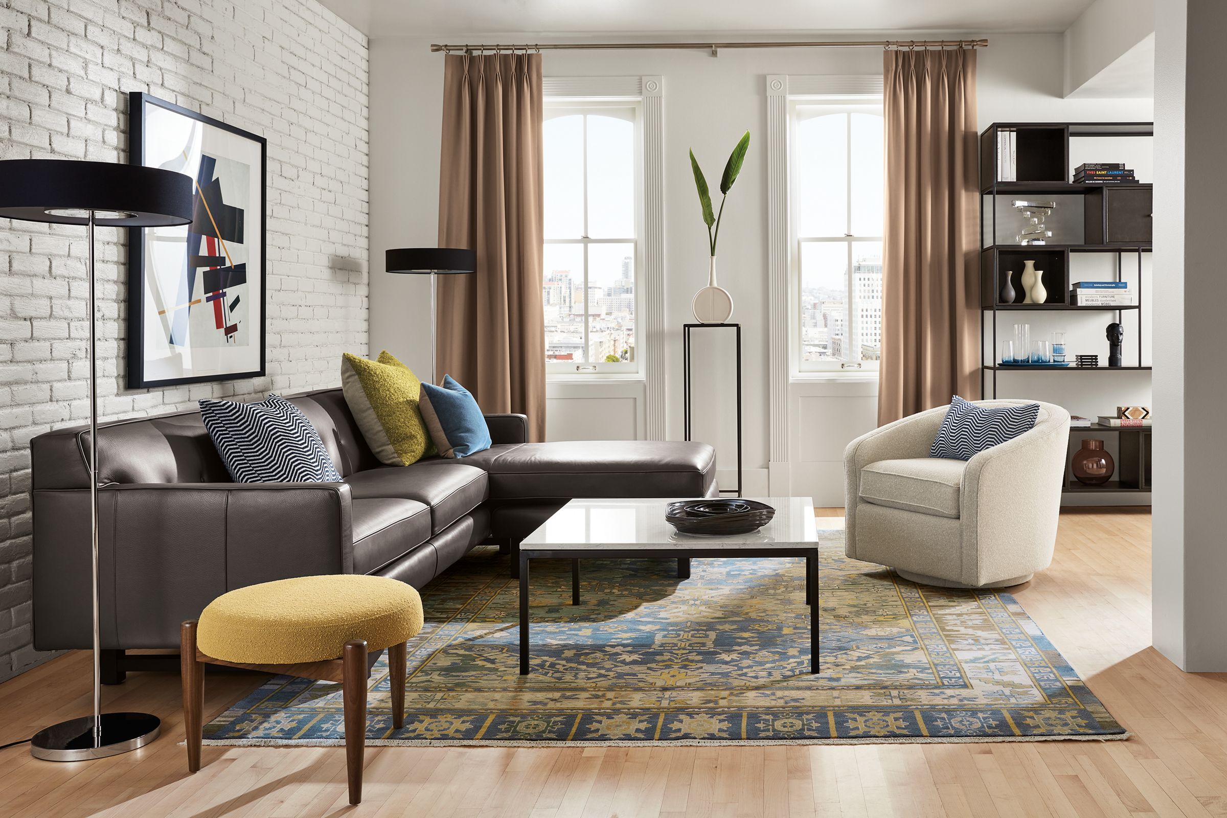 living room with andre leather sofa, amos swivel chair, foshay bookcase with inserts, kayseri rug.