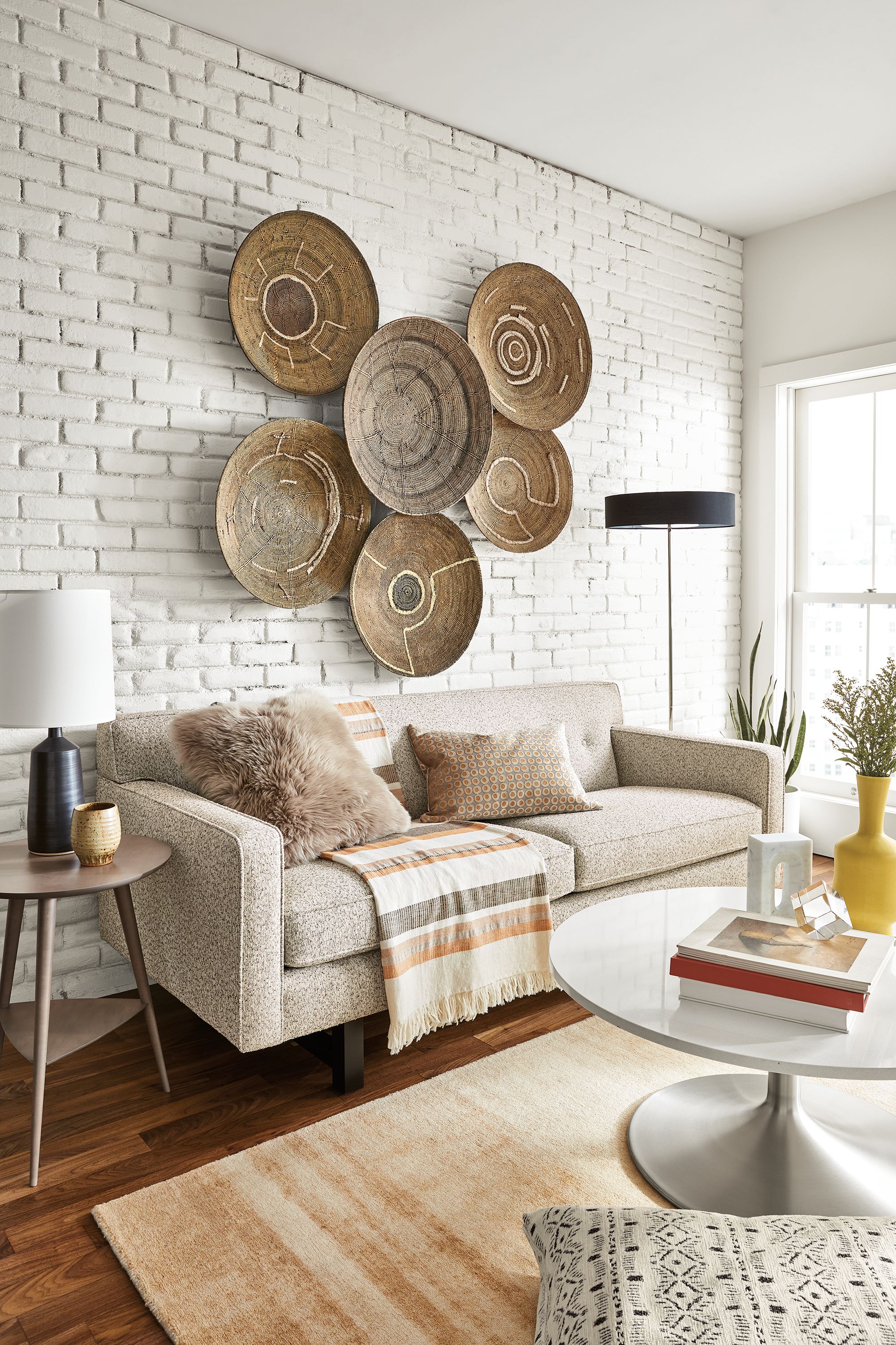 Andre 76-wide Sofa in Conley Oatmeal with various African Makenge baskets above.