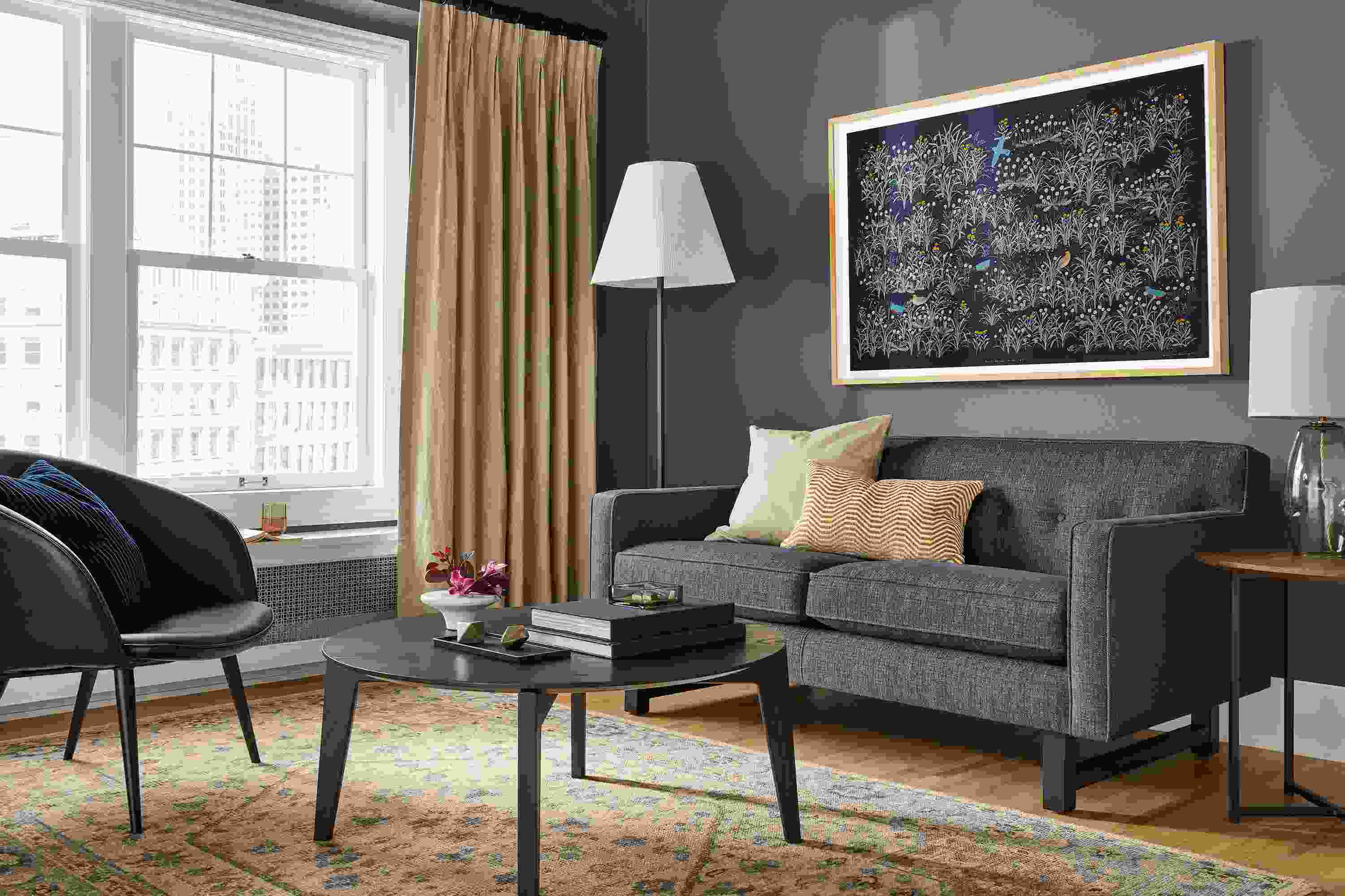Andre 65-wide Loveseat in Total Ink and Orlin 36-Round Coffee Table in Charcoal.
