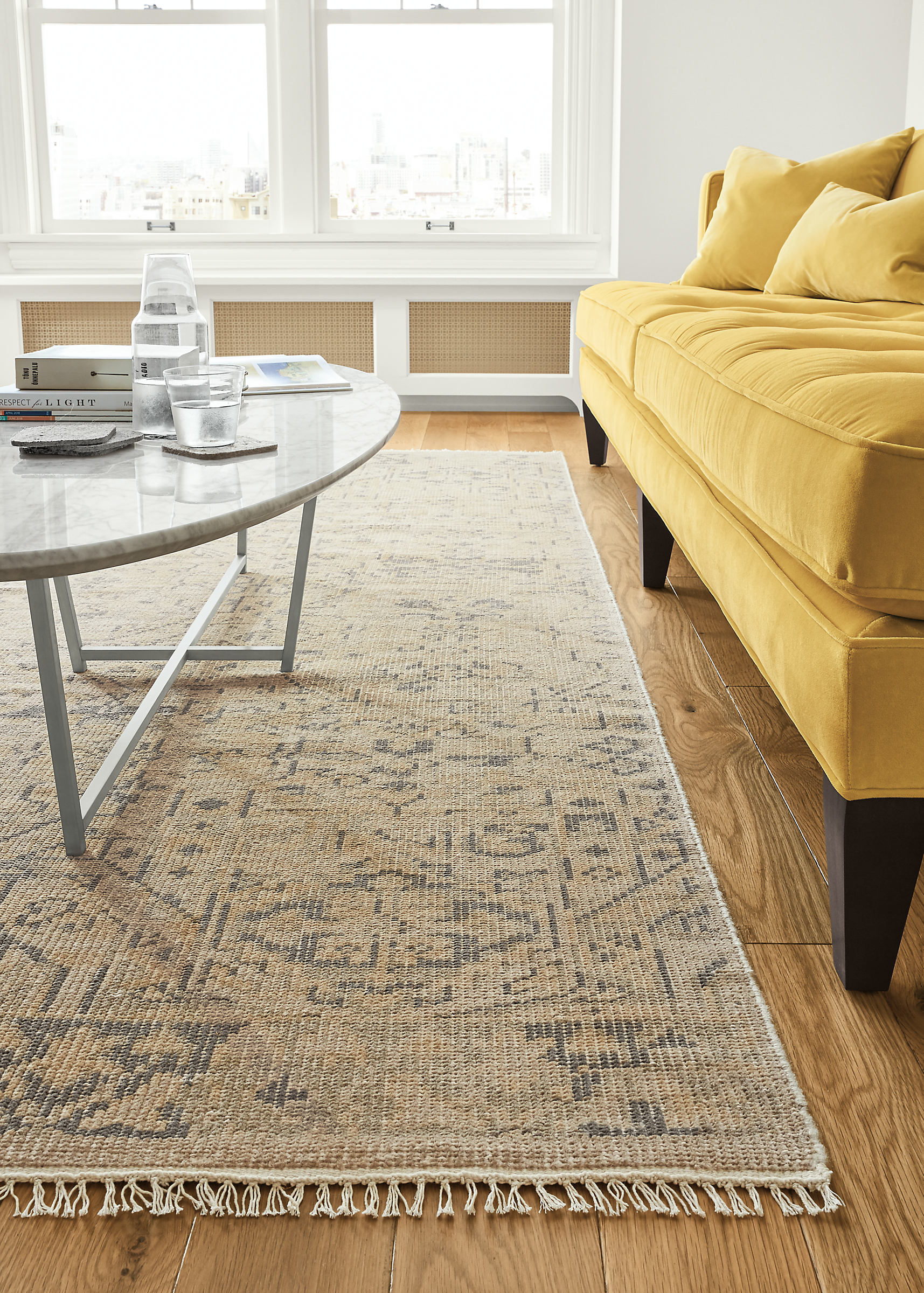 Detail of Anjora rug in grey/maize in living room.