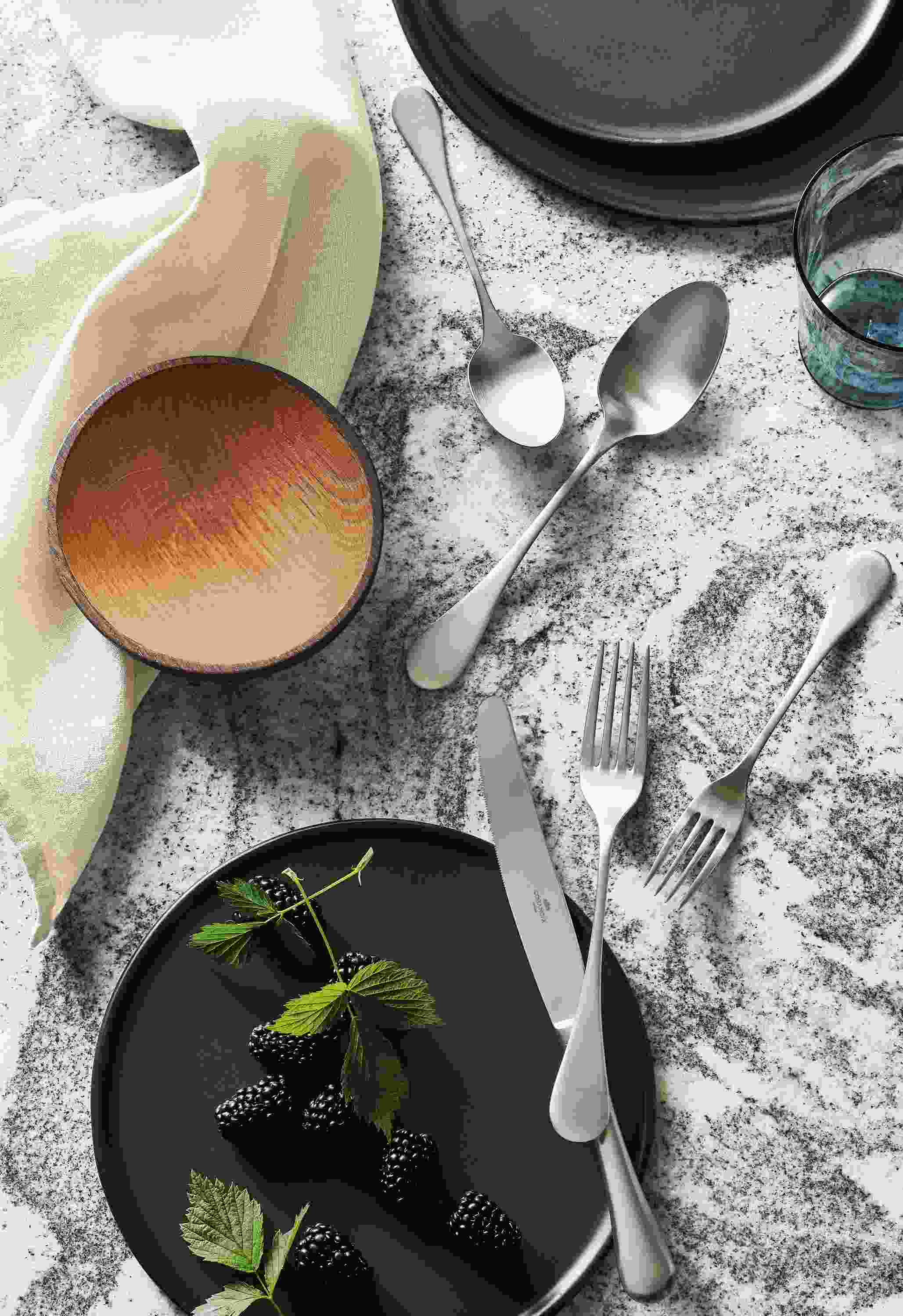 granite tabletop with antigo flatware, elliott bowl, nadia plates.