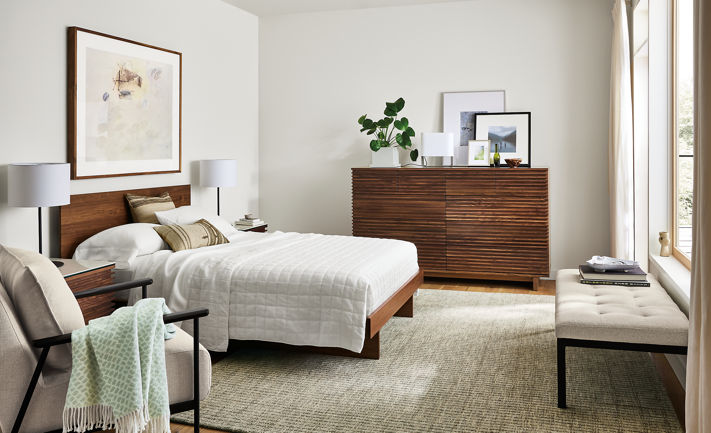 Bedroom with Anton queen bed in walnut and coles ten-drawer dresser in walnut with Nera rug in stone.