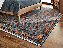 Detail of Anza rug in blue/blush in bedroom.