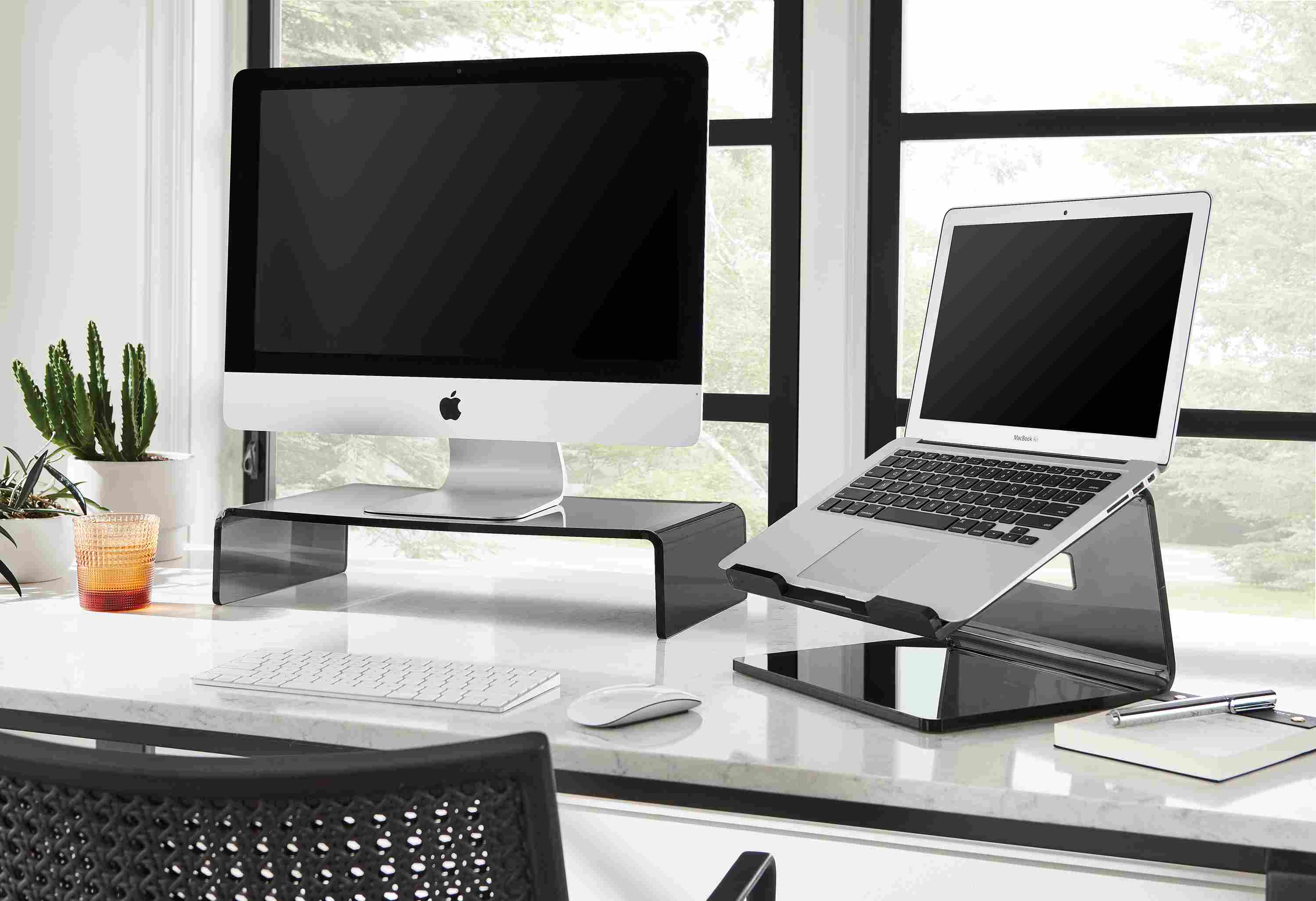 Office space with Rand table with Arcana risers for laptop computer and monitor in smoke.