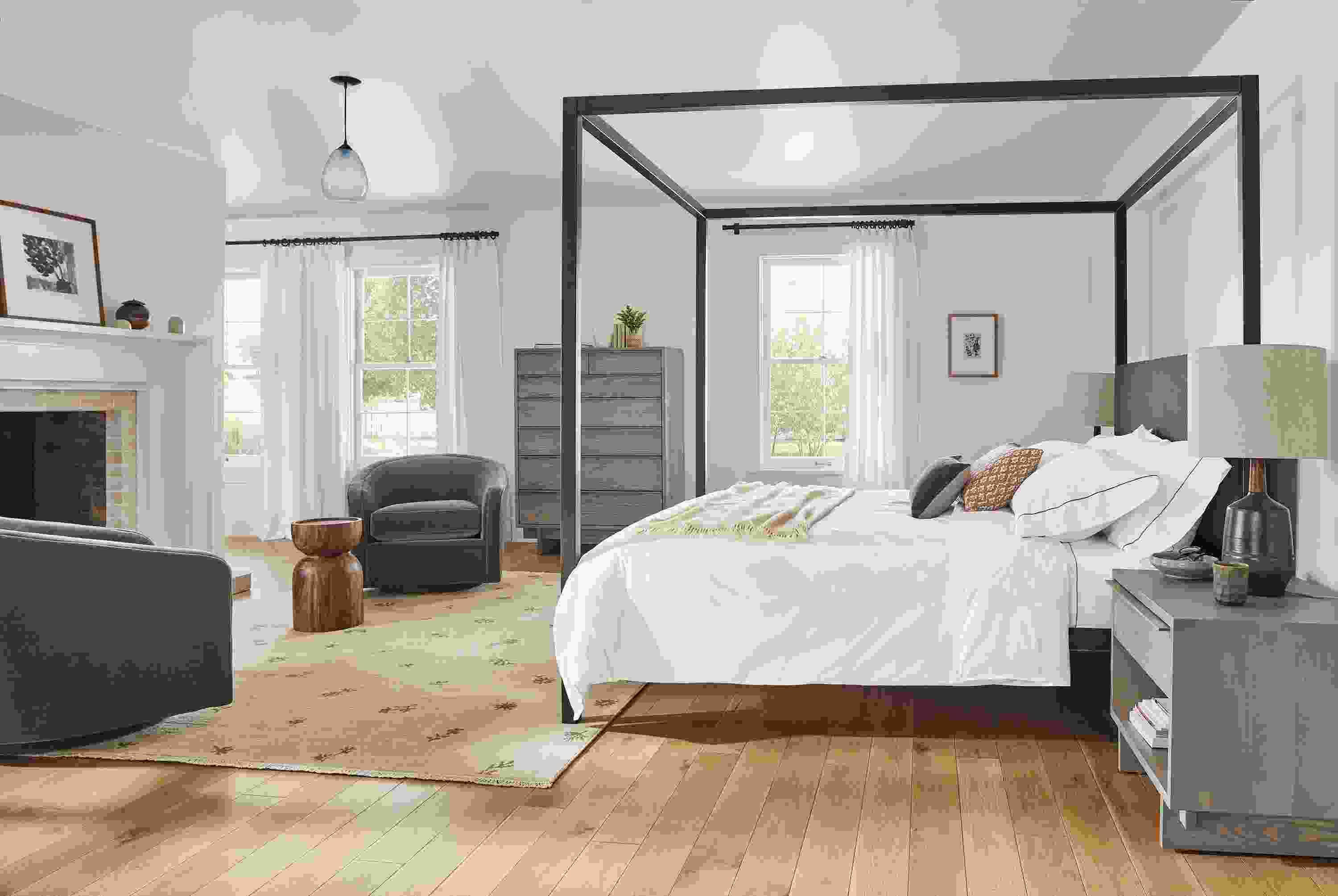 bedroom with fireplace, architecture canopy bed, tansy rug, amos swivel chair, anton dresser and anton nightstands.