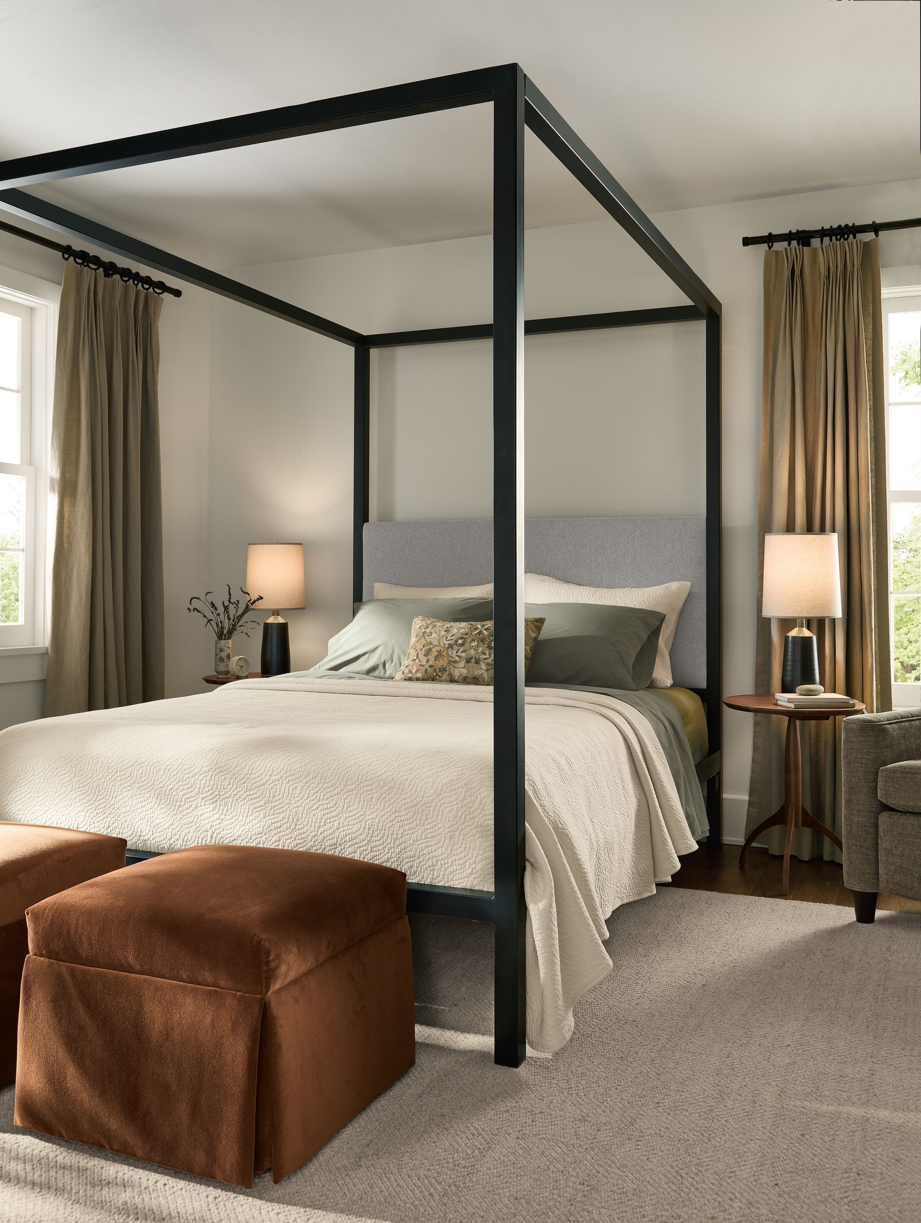 Bedroom with Architecture queen bed in Derry Cement,  and 2 Esther ottomans in Redding Nutmeg.