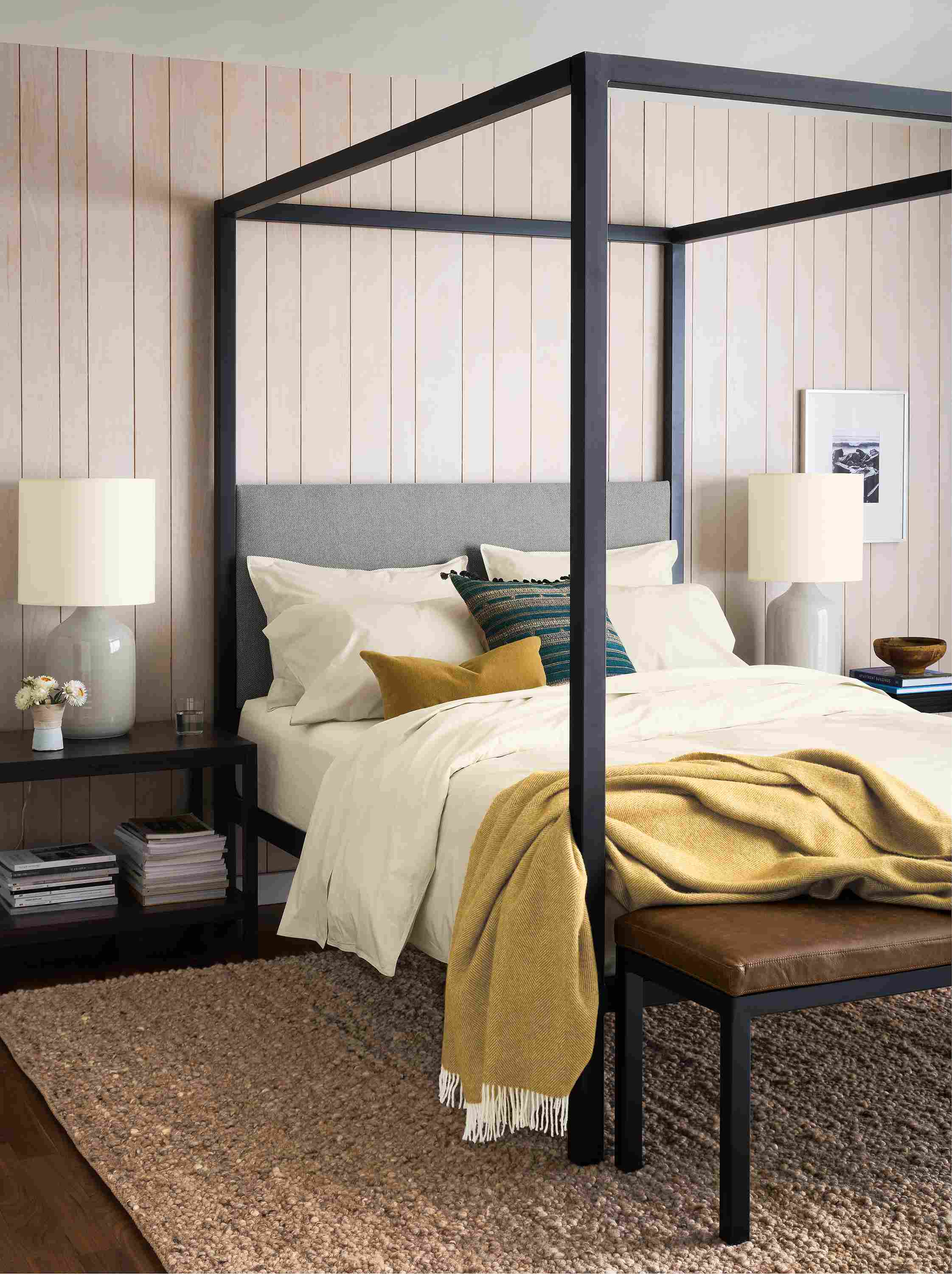 Bedroom with architecture queen bed in derry cement, clark end table in charcoal and cobble 8 by 10 rug in putty.