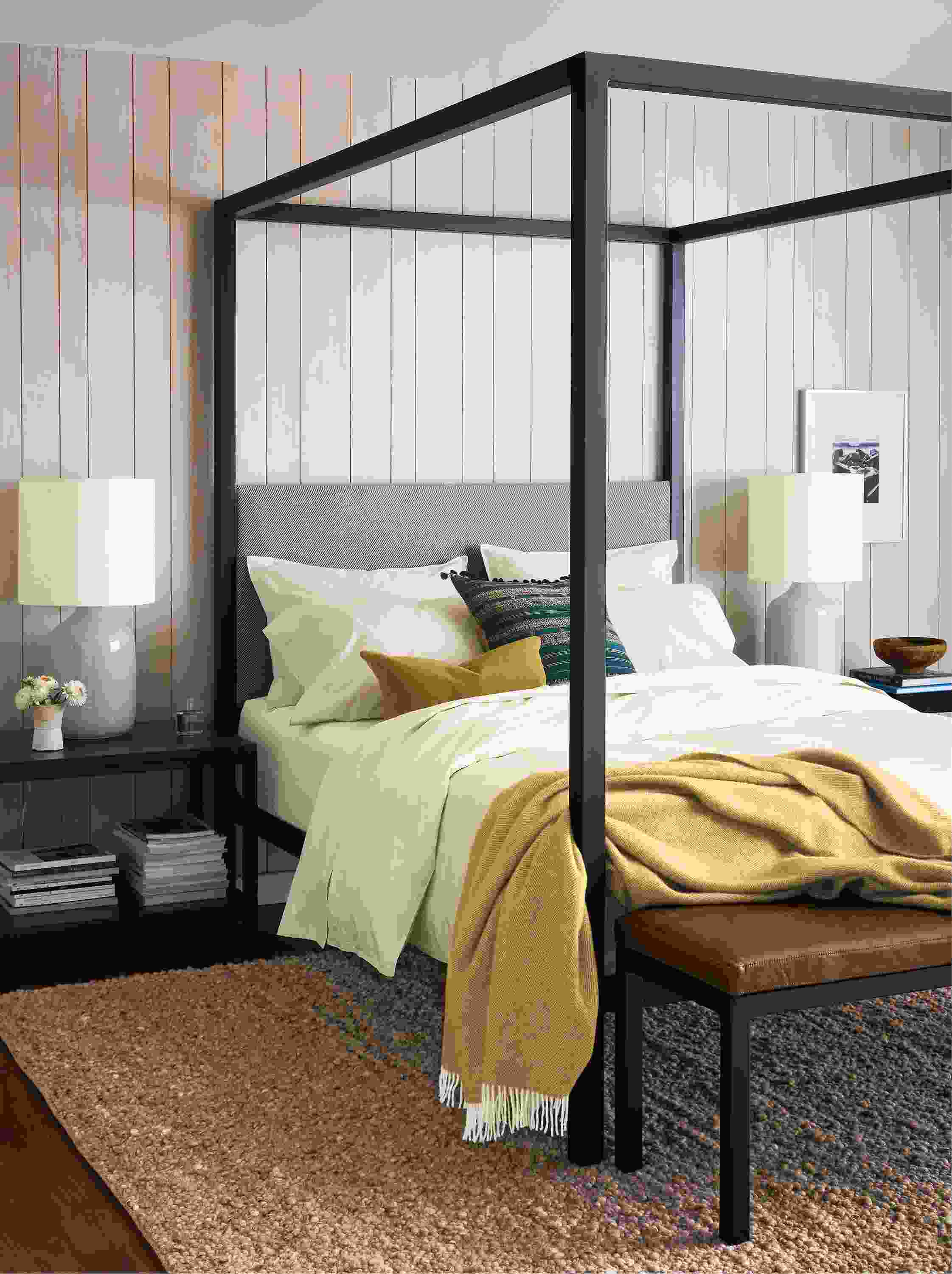 Bedroom with architecture queen bed in derry cement, clark end table in charcoal and cobble 8 by 10 rug in putty.