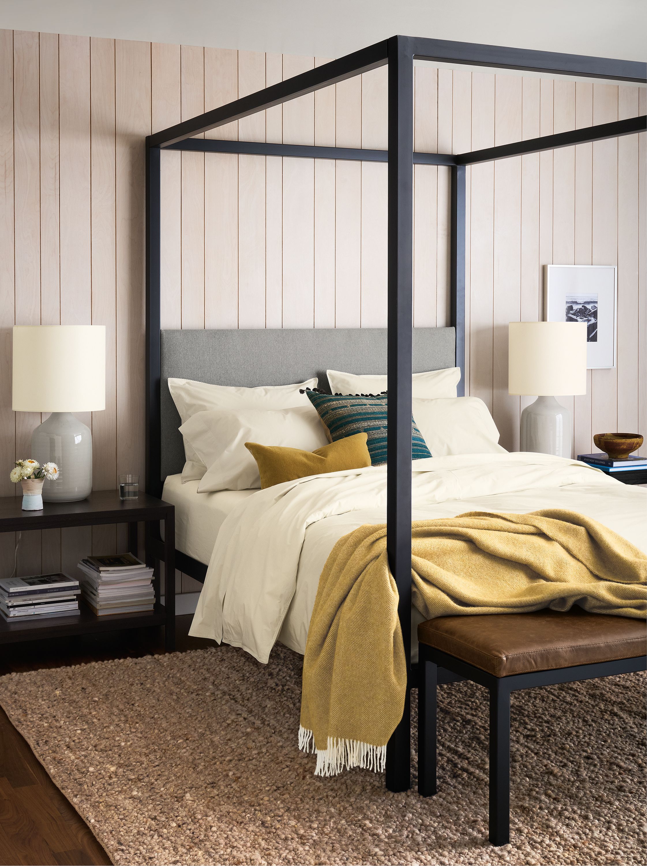 Bedroom with architecture queen bed in derry cement, clark end table in charcoal and cobble 8 by 10 rug in putty.