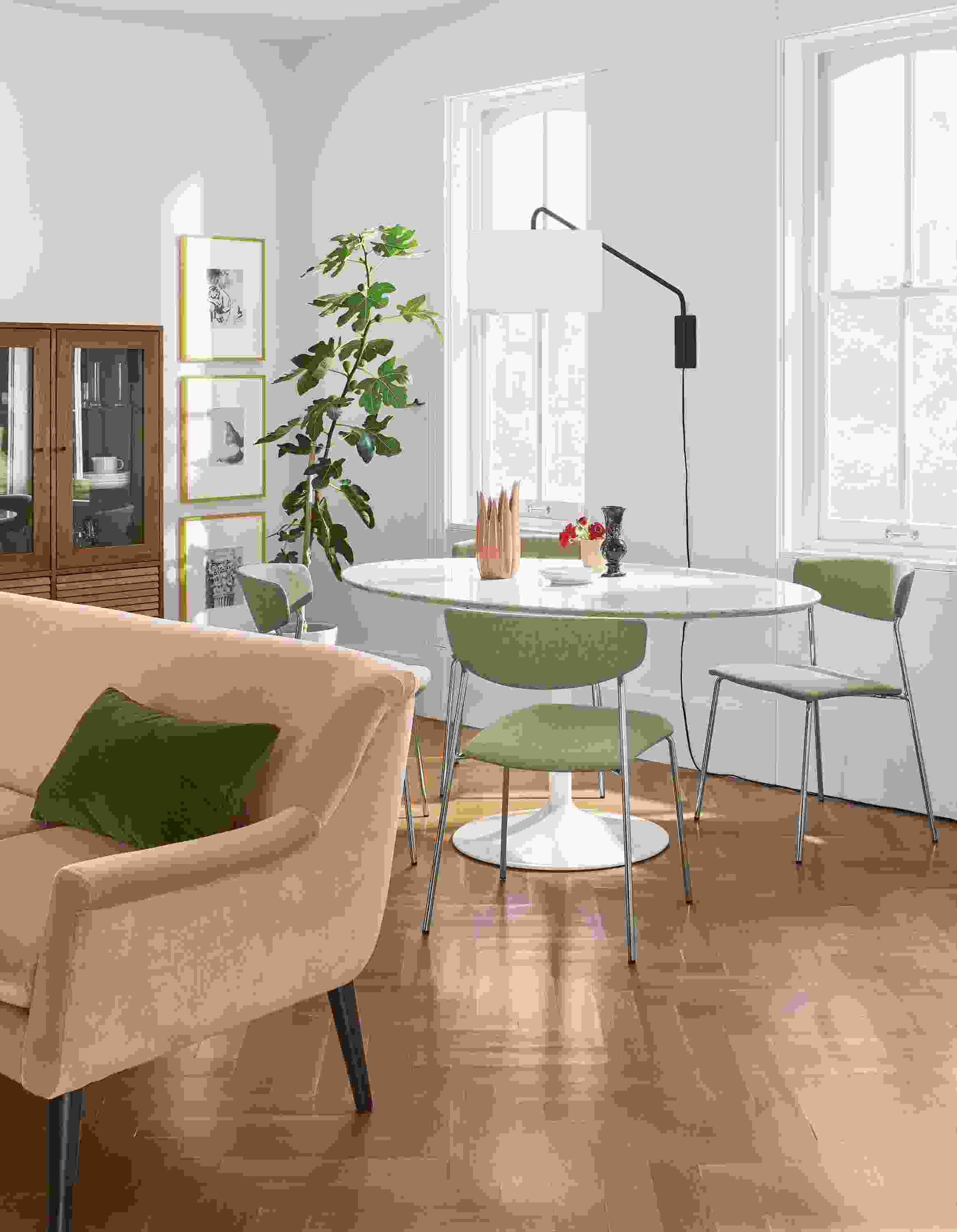 Detail of Aria 60-wide oval table in white with Wolfgang side chairs.