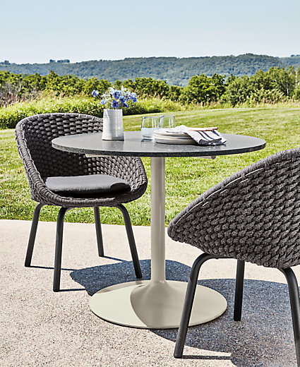 Aria 36-round outdoor table with two flet chairs in slate.