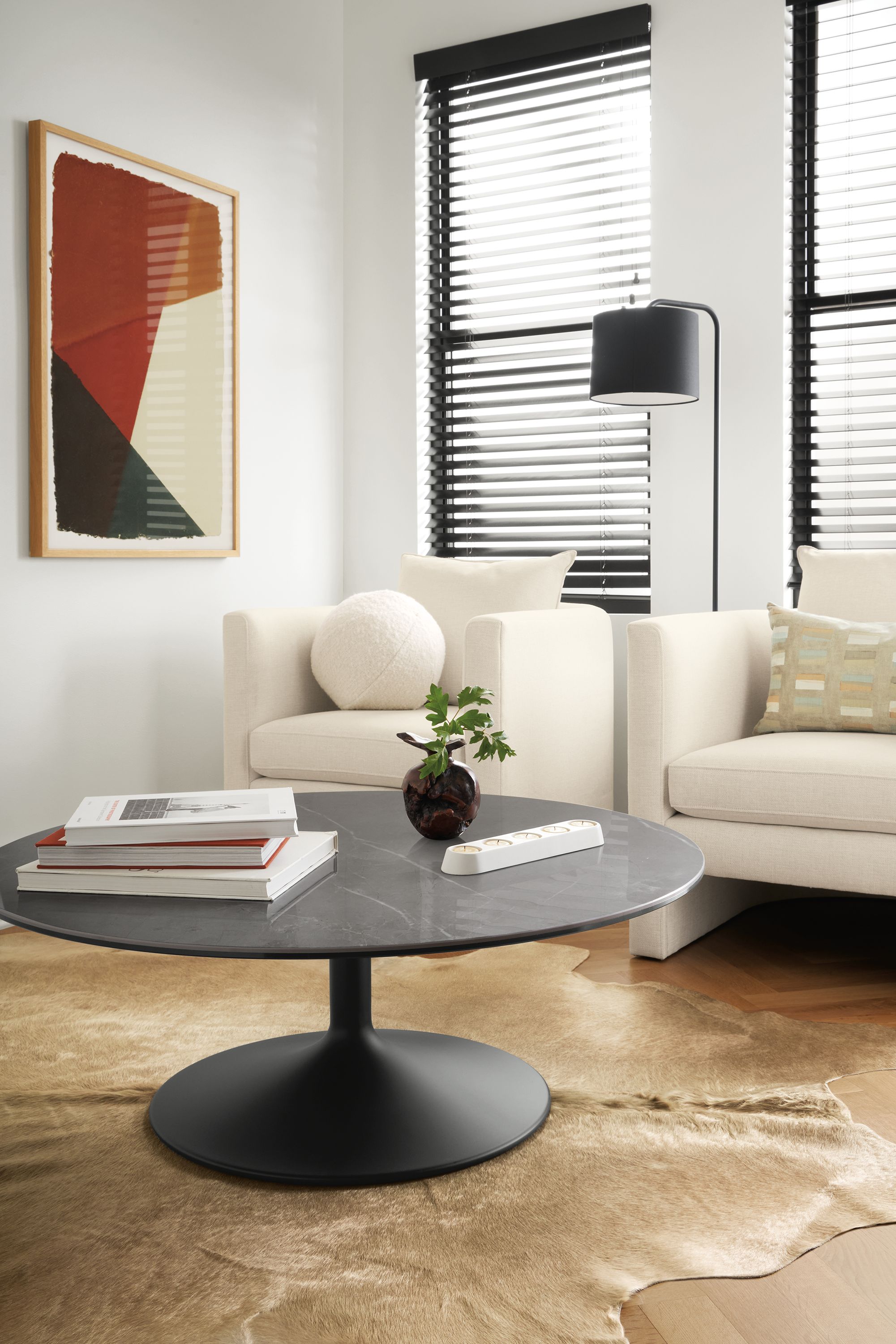 Aria 42-Round Coffee Table In graphite with grey marbled ceramic top and Silva Chairs in Sumner Ivory.