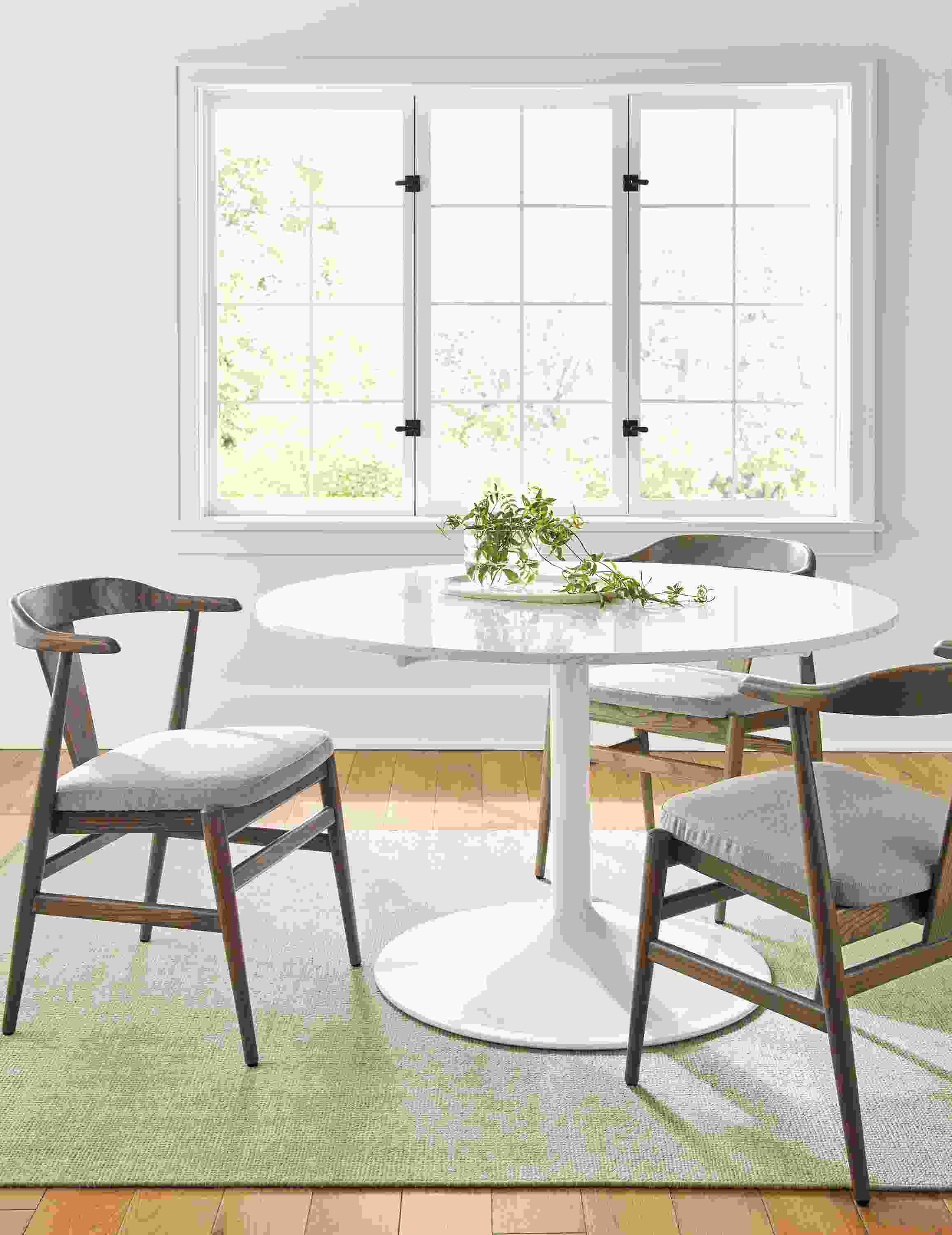 Aria 48-Round Tablewith Evan Arm Chair in Shell and Flint Fabric.
