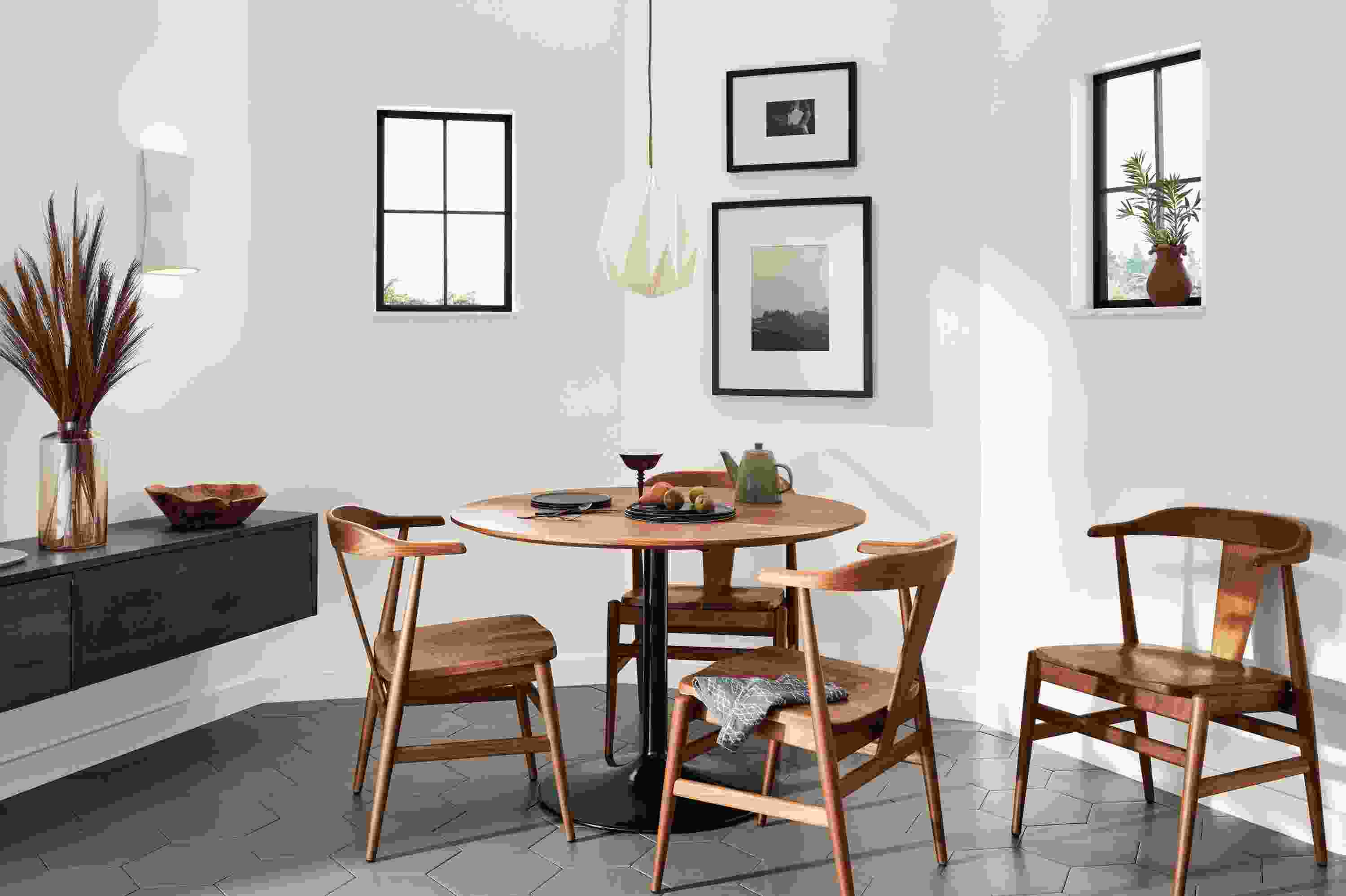 Aria 42-Round Table in onyx with walnut top and Evans chairs.
