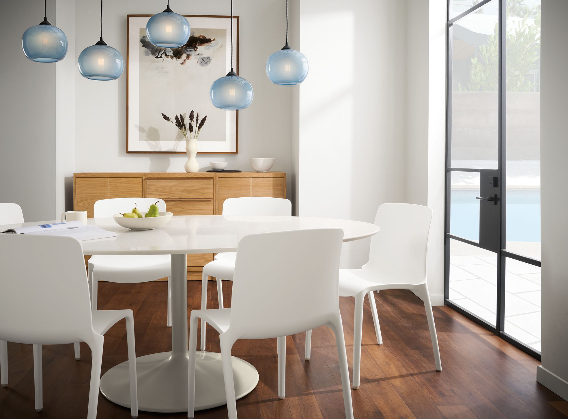 dining room with white Aria oval table in taupe with light grey quartz top and  tiffany side chairs in white.