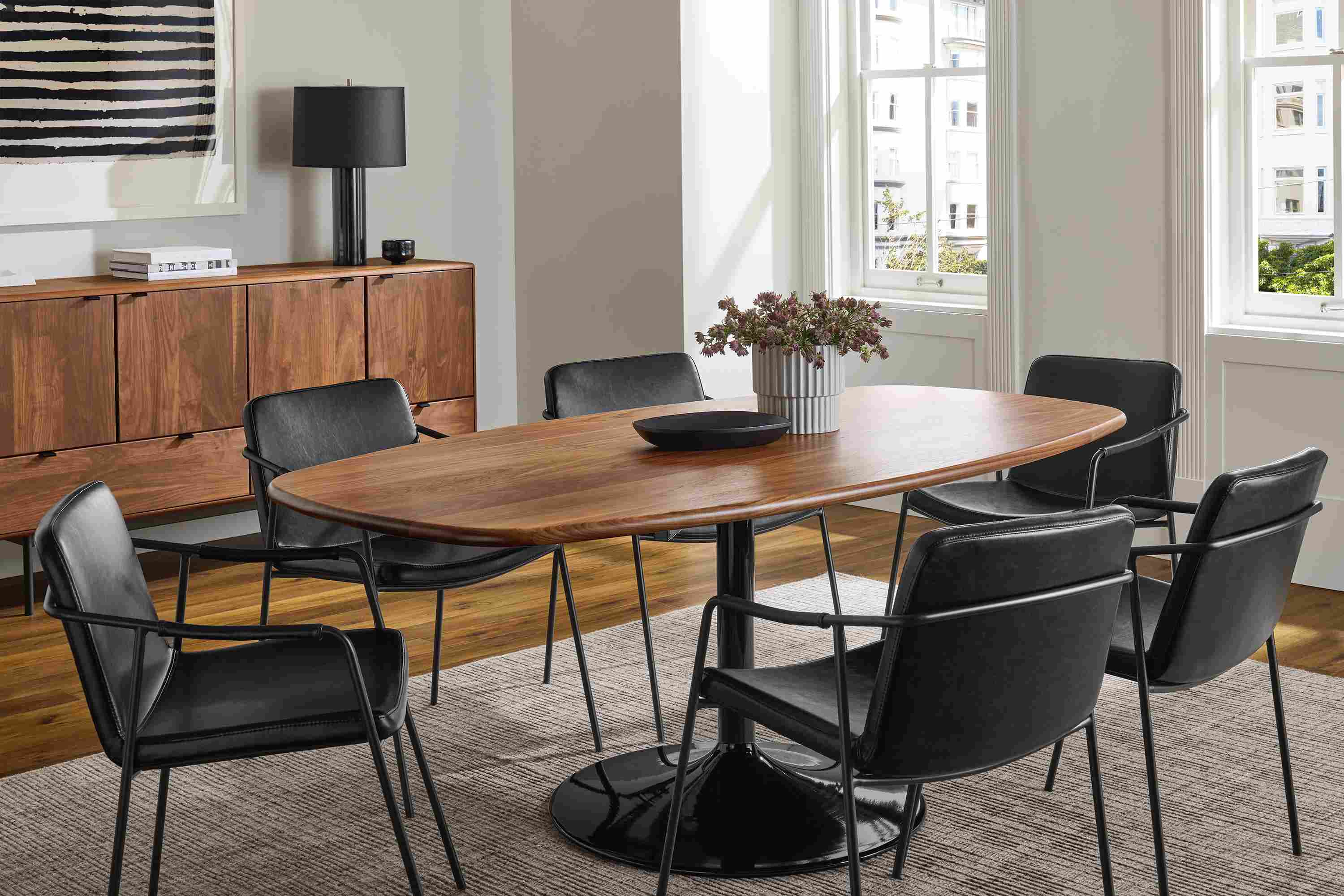 Dining room with Aria 76-wide Boat-Top Table in onyx gloss and walnut and 6 Maize chairs in Nola Graphite leather.