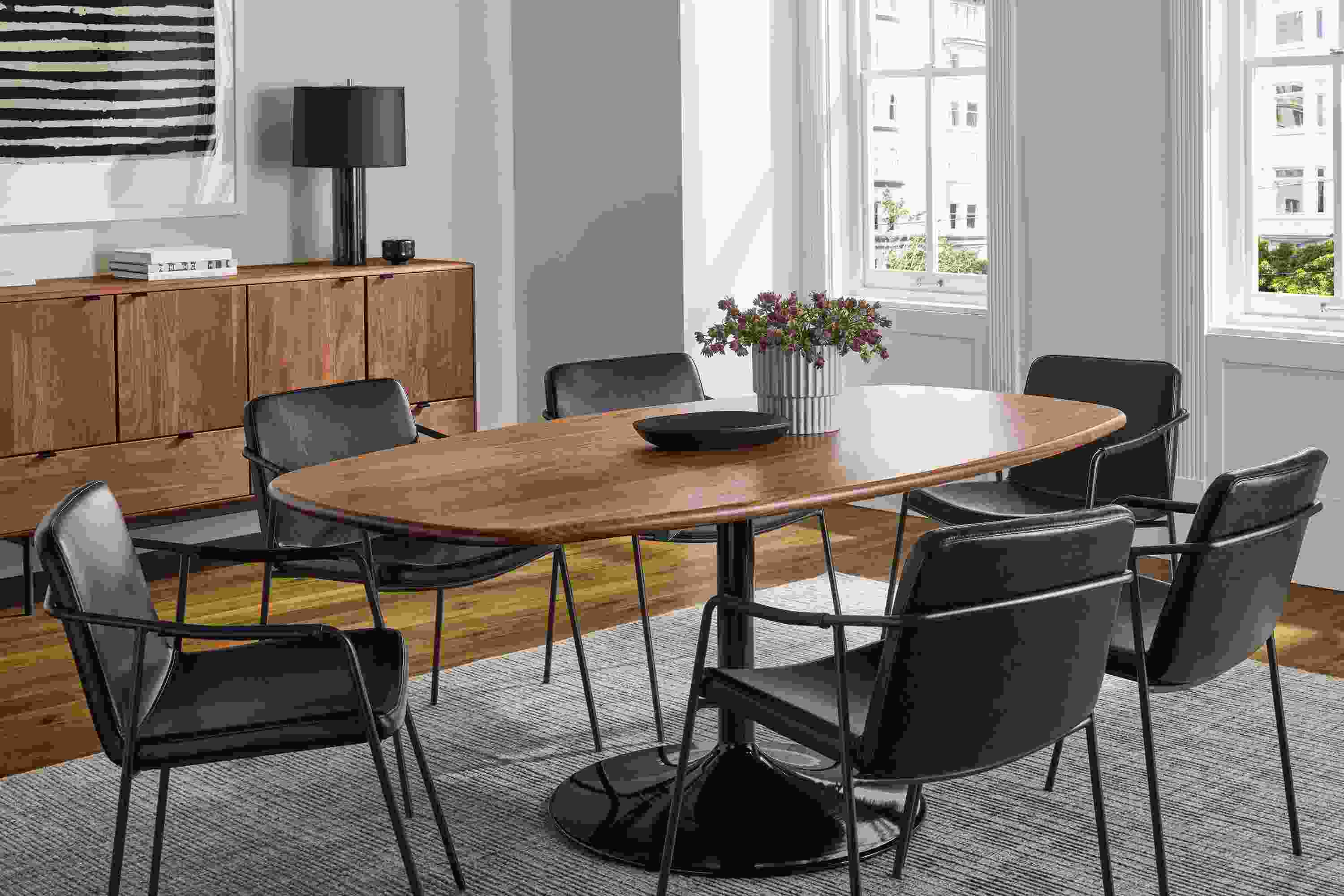 Dining room with Aria 76-wide Boat-Top Table in onyx gloss and walnut and 6 Maize chairs in Nola Graphite leather.