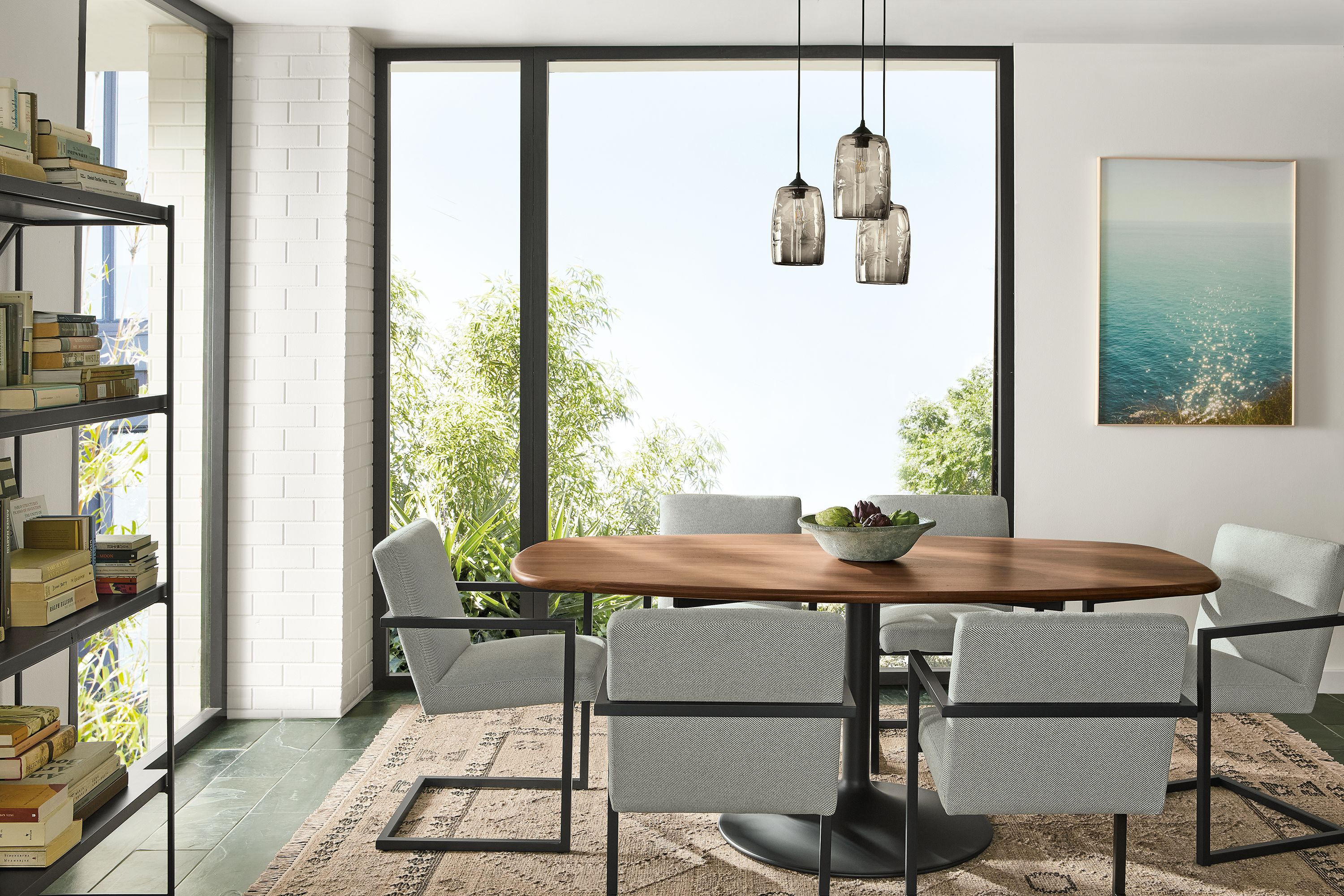 Dining room with Aria 76-wide boat top table in walnut and graphite and Lira arm chair in Derry slate.