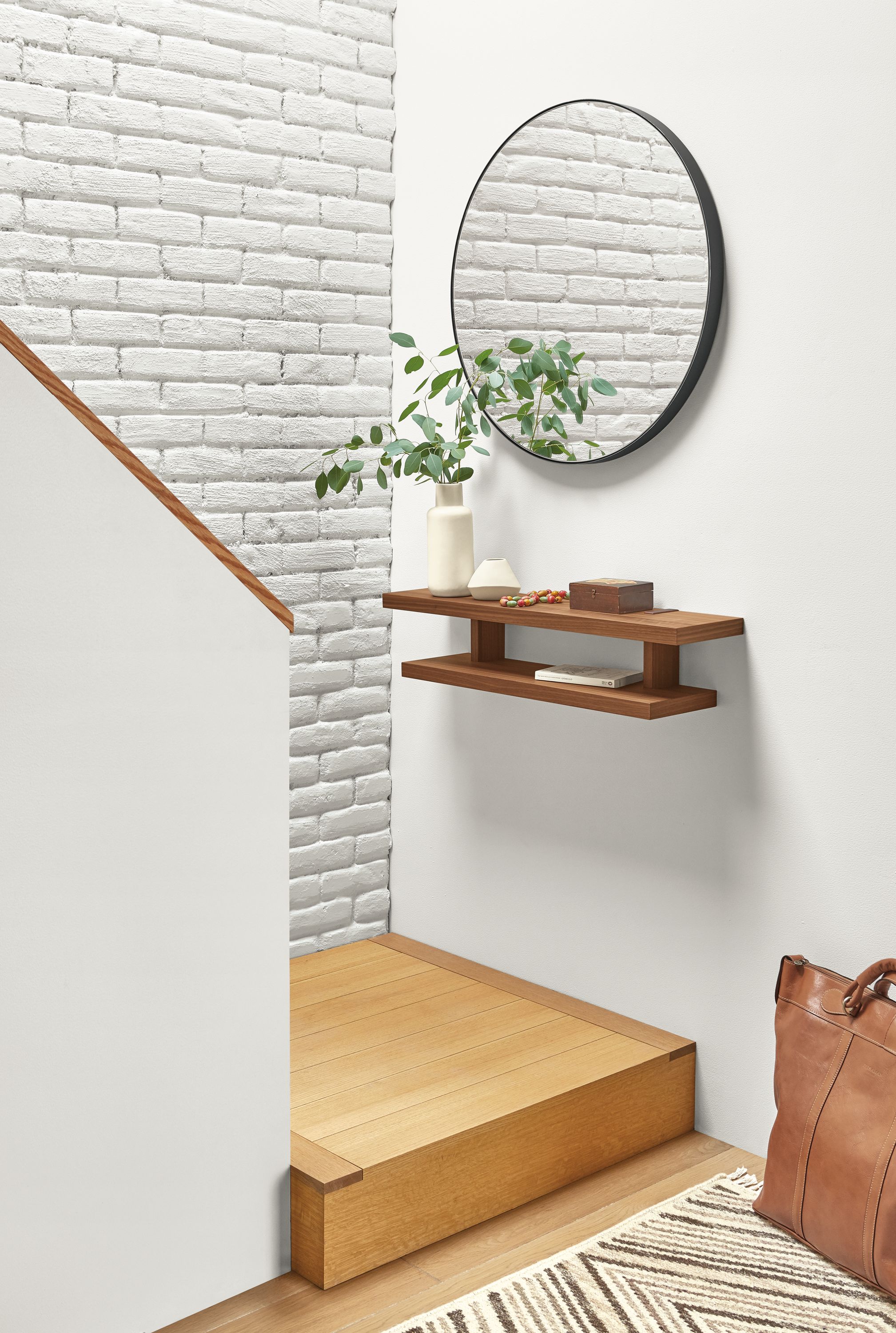 Detail of Arista wall shelf in walnut in entryway setting.