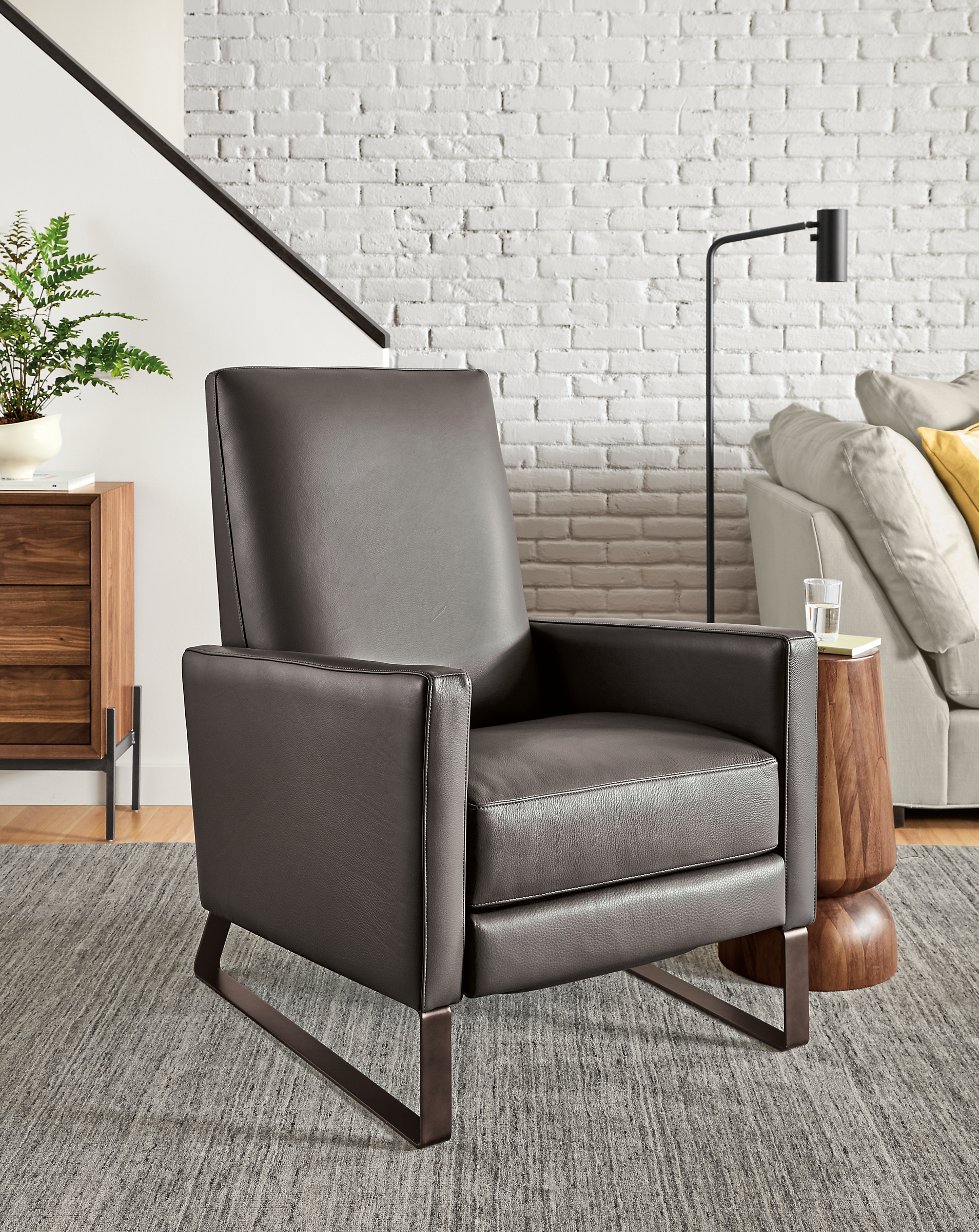 Detail of Arlo Thin-Arm Recliner in Urbino Smoke Leather with steel sled  base.
