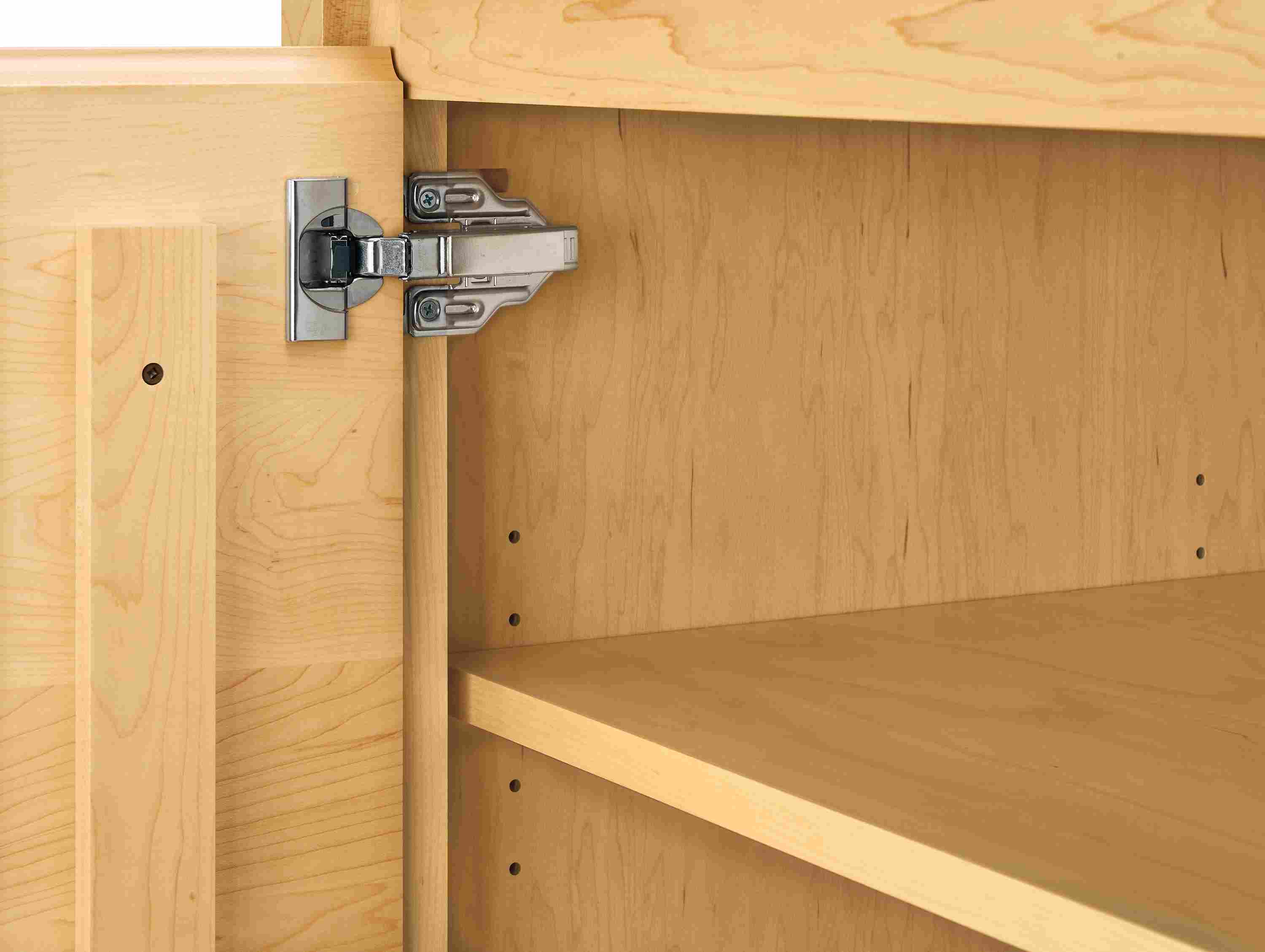 Detail of door hinge on arro 72-wide storage cabinet in maple.