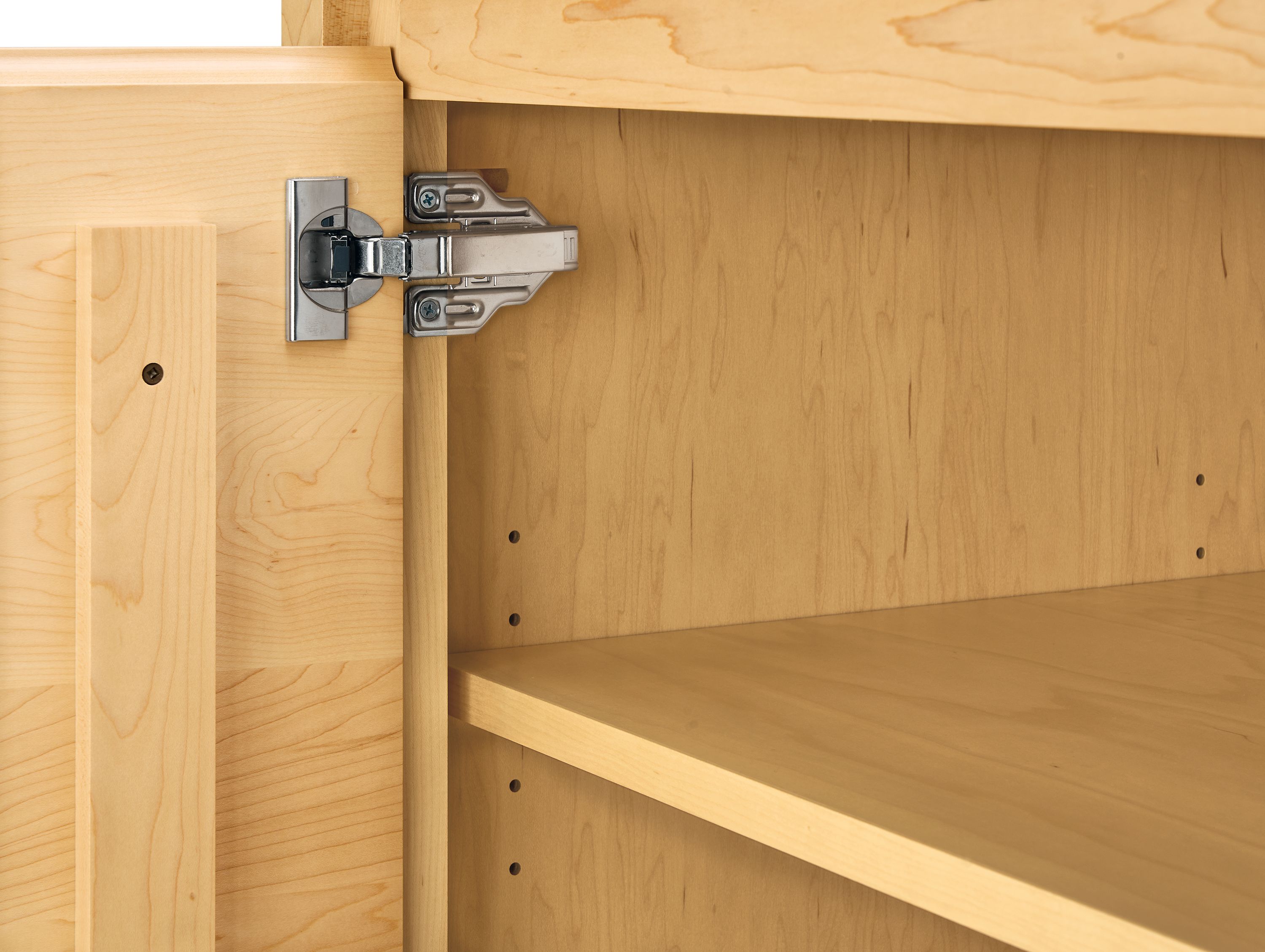 Detail of door hinge on arro 72-wide storage cabinet in maple.