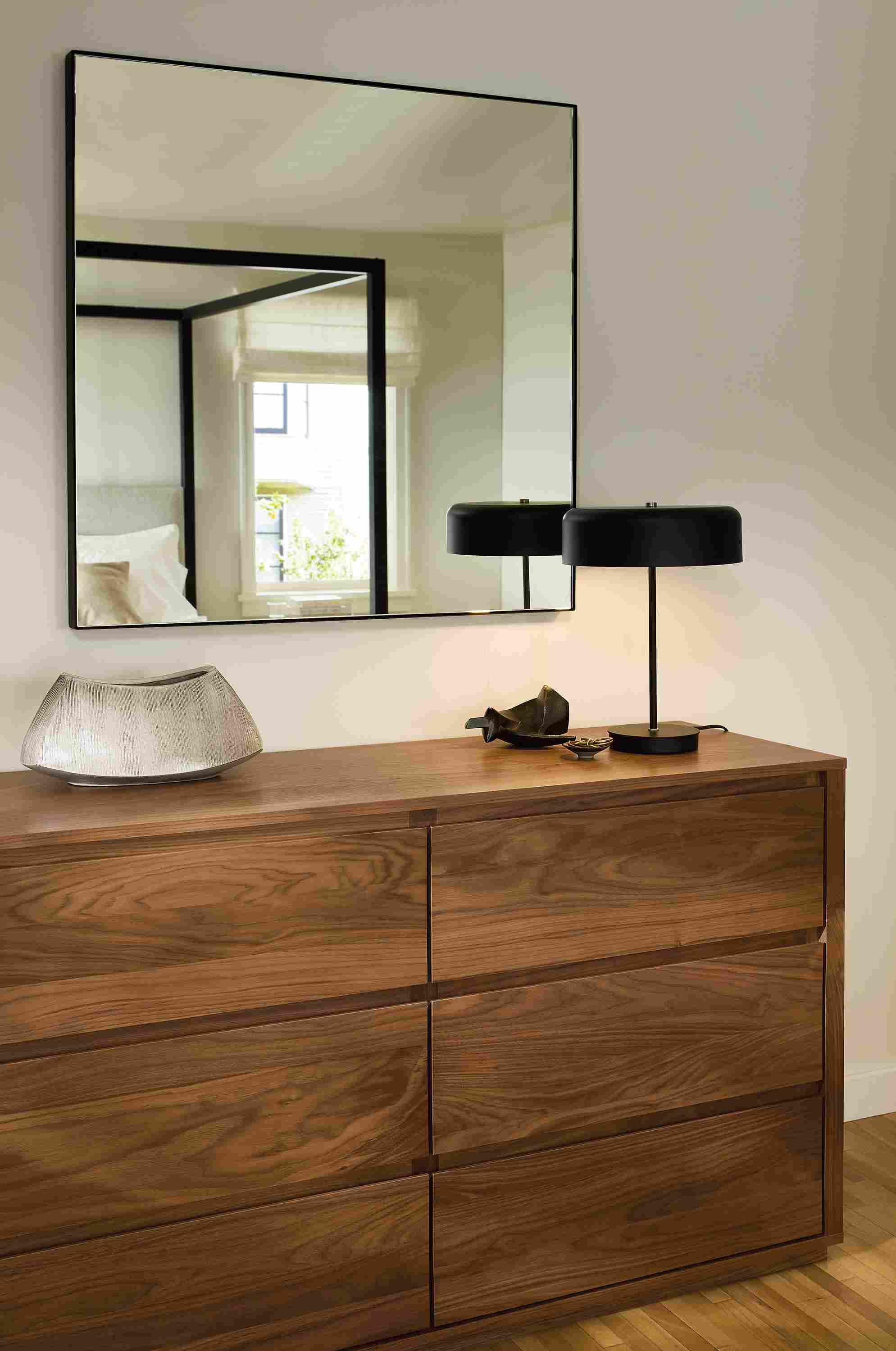 Bedroom with detail of Arro 6-drawer dresser in walnut and infiinity 36-square wall mirror in graphite.