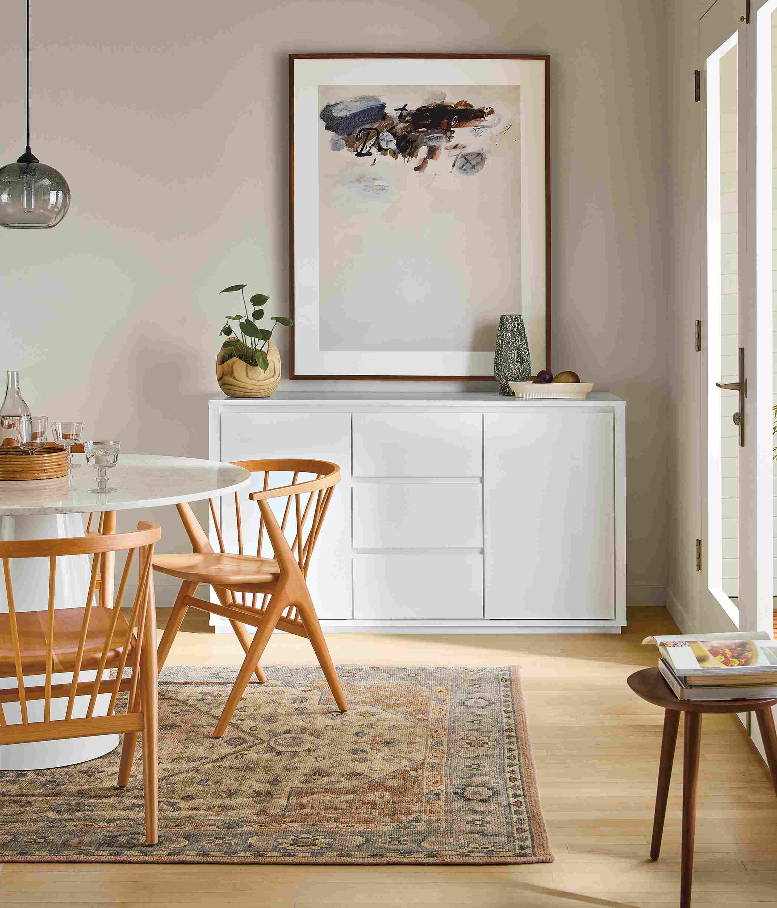 Dining room with Arro 60-wide storage cabinet in white, decker round table in white and soren chairs in cherry.