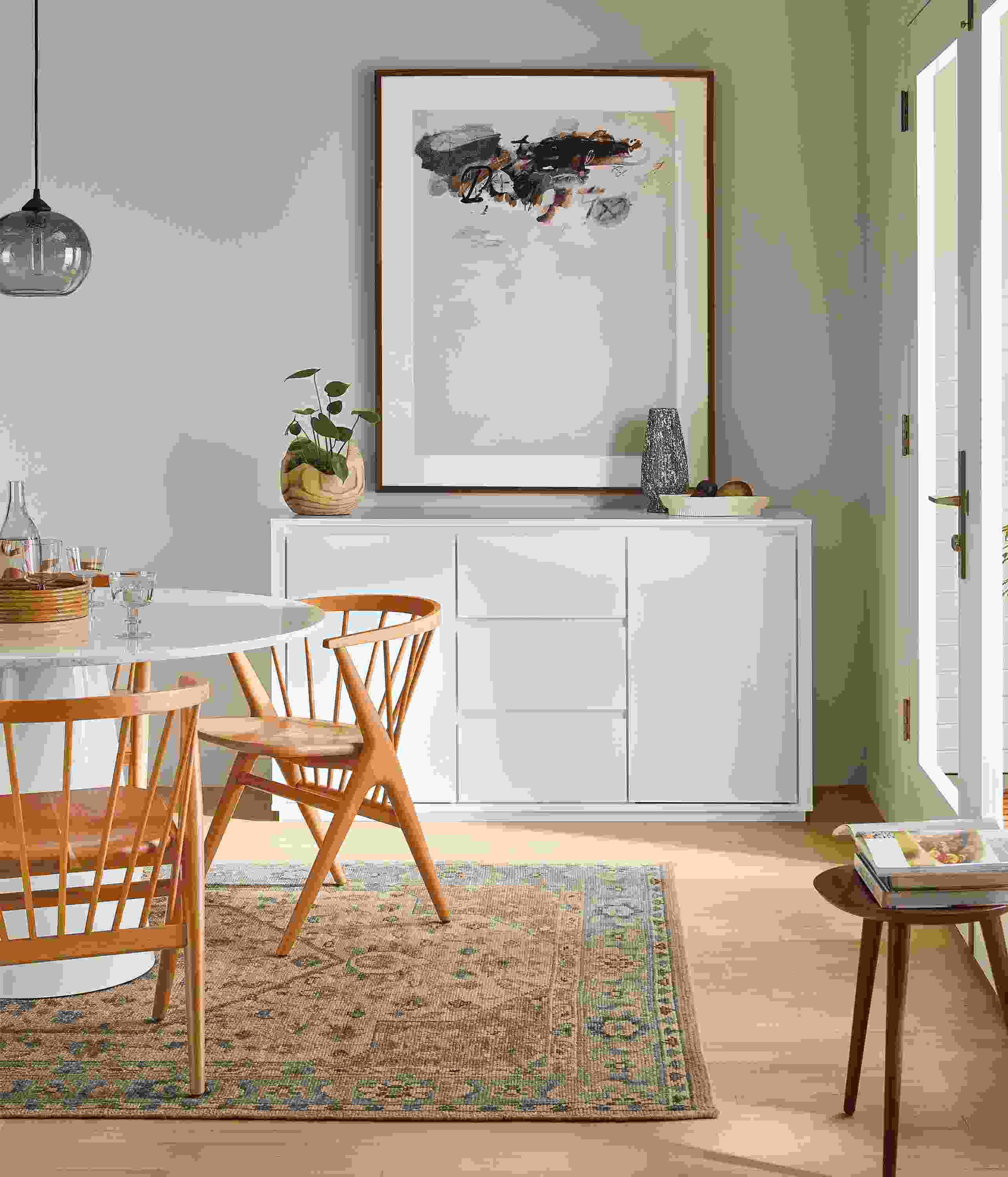 Dining room with Arro 60-wide storage cabinet in white, decker round table in white and soren chairs in cherry.