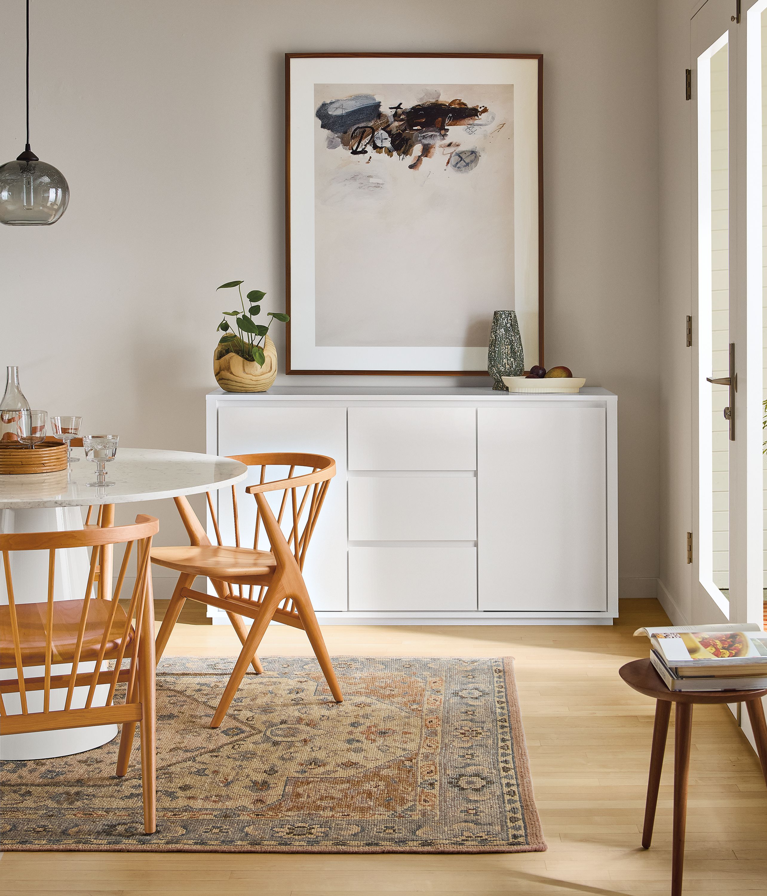 Dining room with Arro 60-wide storage cabinet in white, decker round table in white and soren chairs in cherry.
