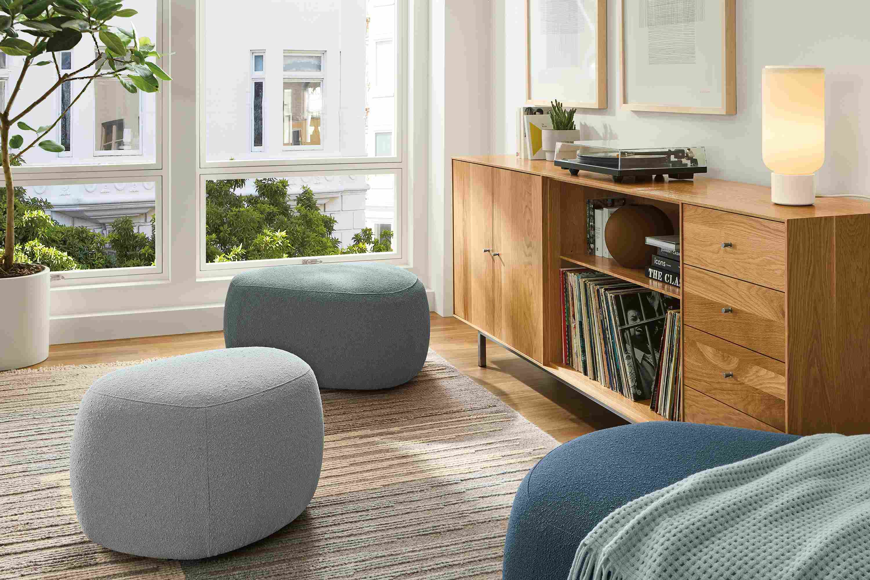 Living room with Asher ottoman harbor ensemble set of 3 in cement, haze and harbor colors and Tangier rug in natural.