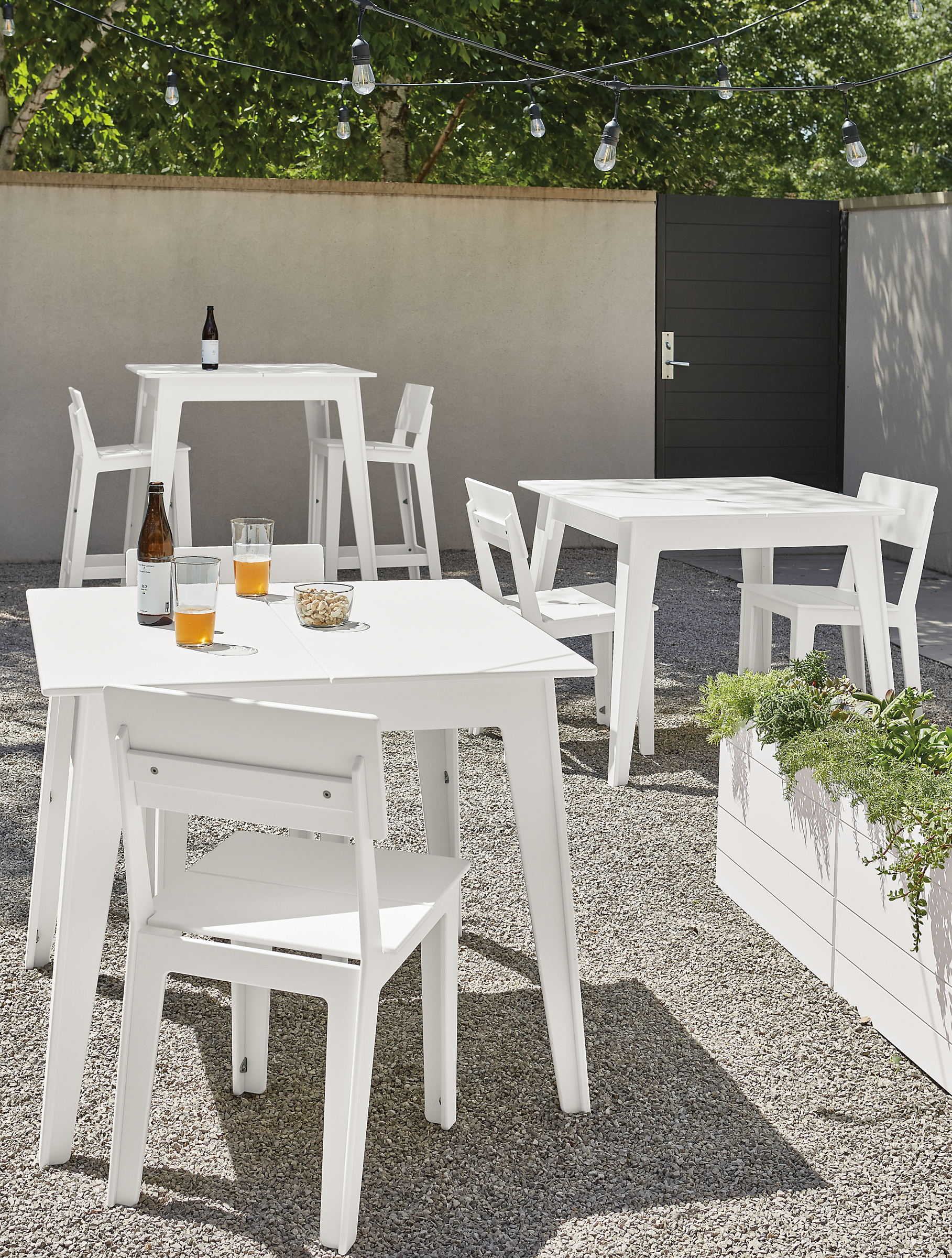 outdoor space with aspen dining tables, aspen counter table, aspen stools and chairs.