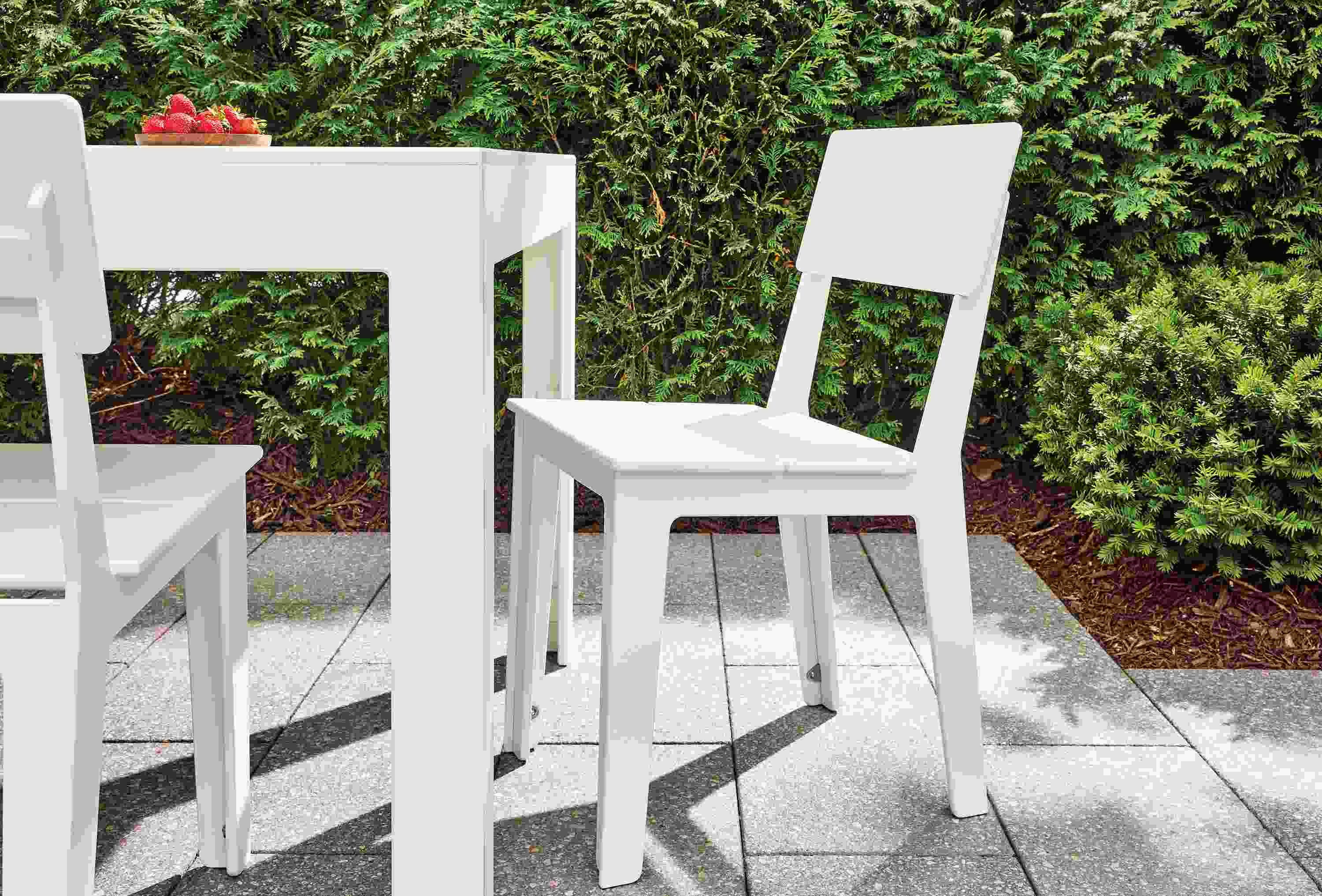 Patio with 2 Aspen side chairs and Henry 80-wide table with umbrella hole in white HDPE.