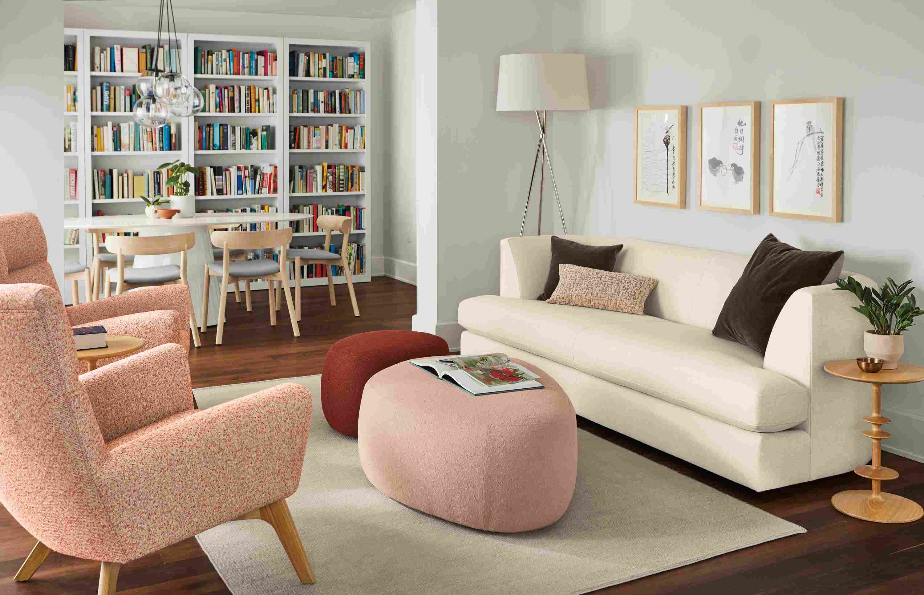 Living room setting with Astaire sofa in sumner ivory, Asher ottomans and Boden chairs in Conley Spice.