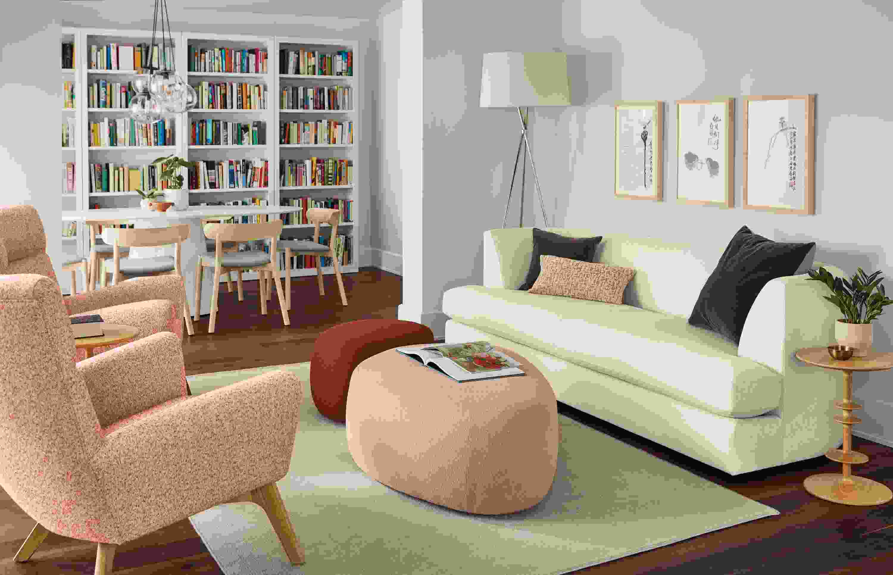 Living room setting with Astaire sofa in sumner ivory, Asher ottomans and Boden chairs in Conley Spice.